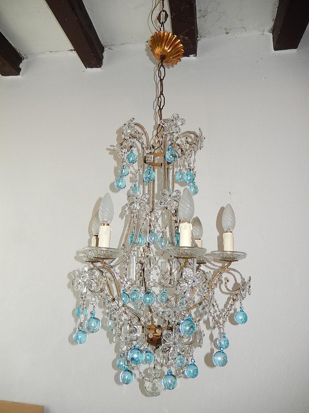 Housing six lights, sitting in rare cut crystal bobeches. Double beading throughout. Swags of crystal beads. The wires look rusty in photos, but this is the fault of the flash. Adorning flowers made of crystal prisms plus rare square crystal prisms