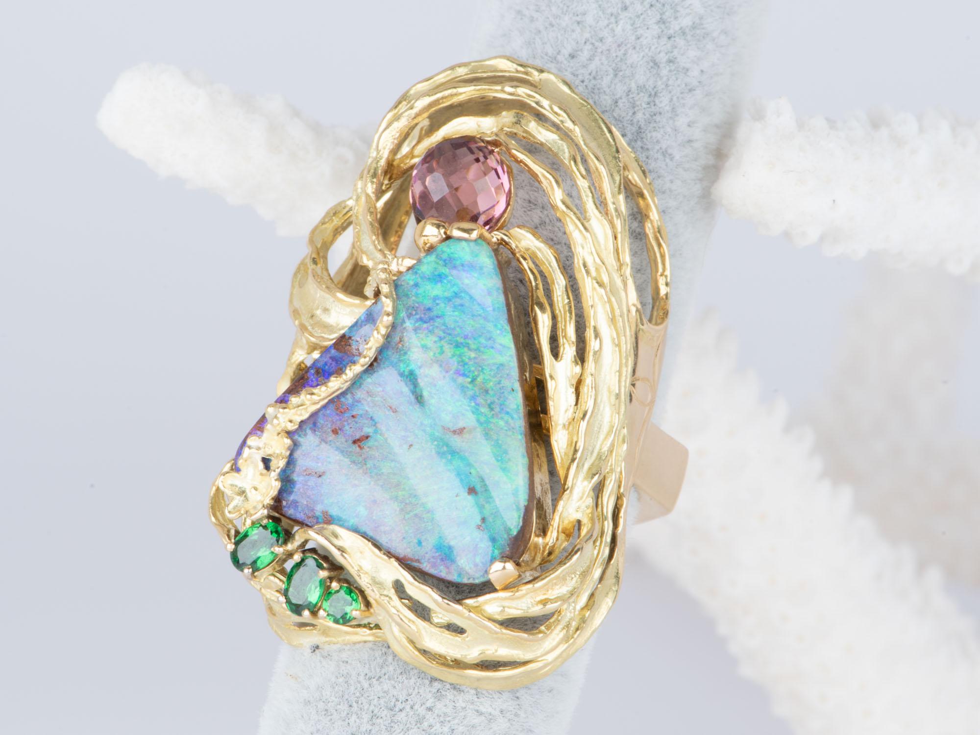 This stunning one-of-a-kind Australian Boulder Opal Ring Pendant Combo is a work of art! Handcrafted in solid 18K gold, it features a flowy organic design and a vibrant mix of colorful gemstones that are sure to captivate the eye. An exclusive and