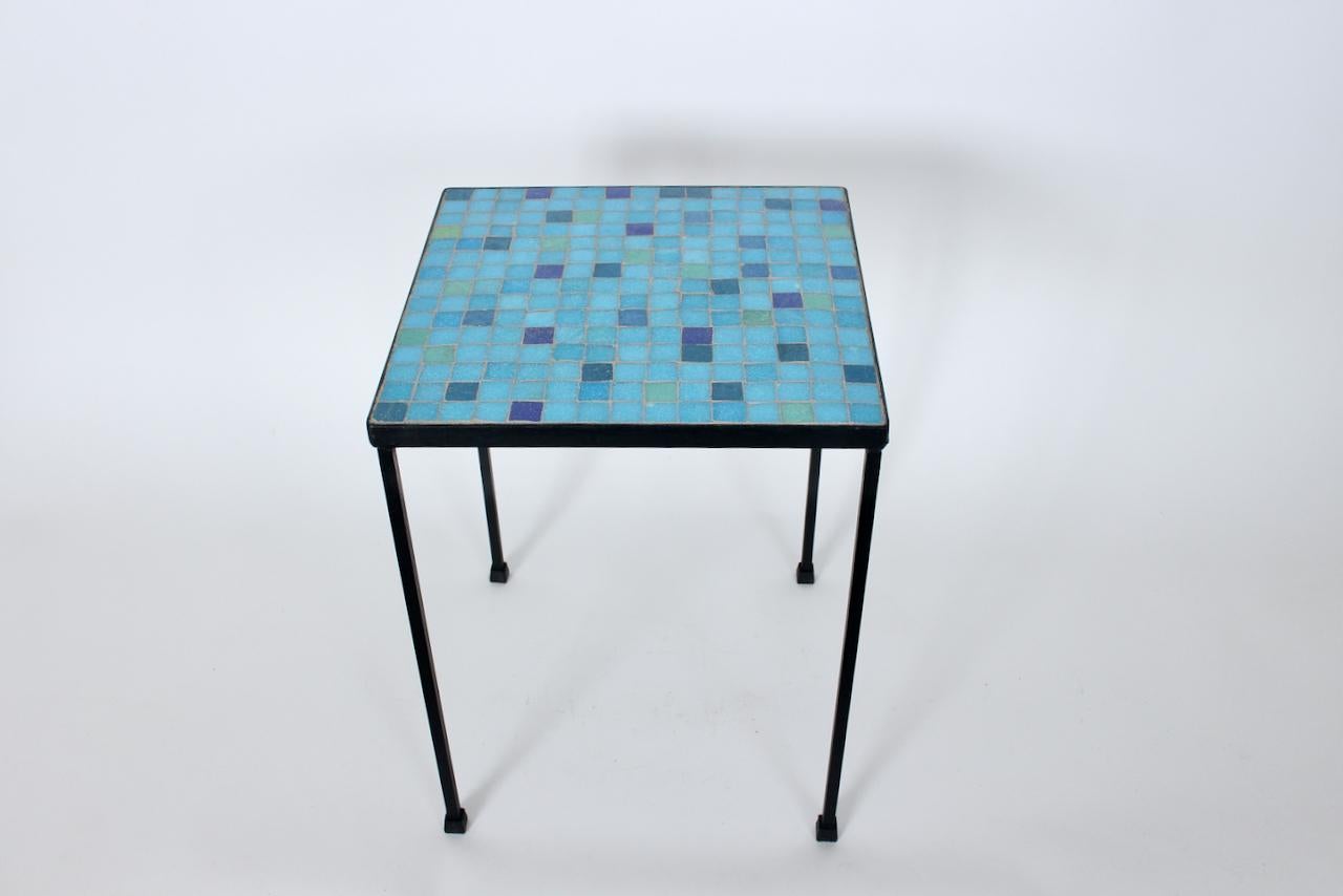 American Mid-Century Modern Black iron and colorful terrazzo tile table. Featuring a sturdy, open square black wrought iron framework, inset with reflective 13/16