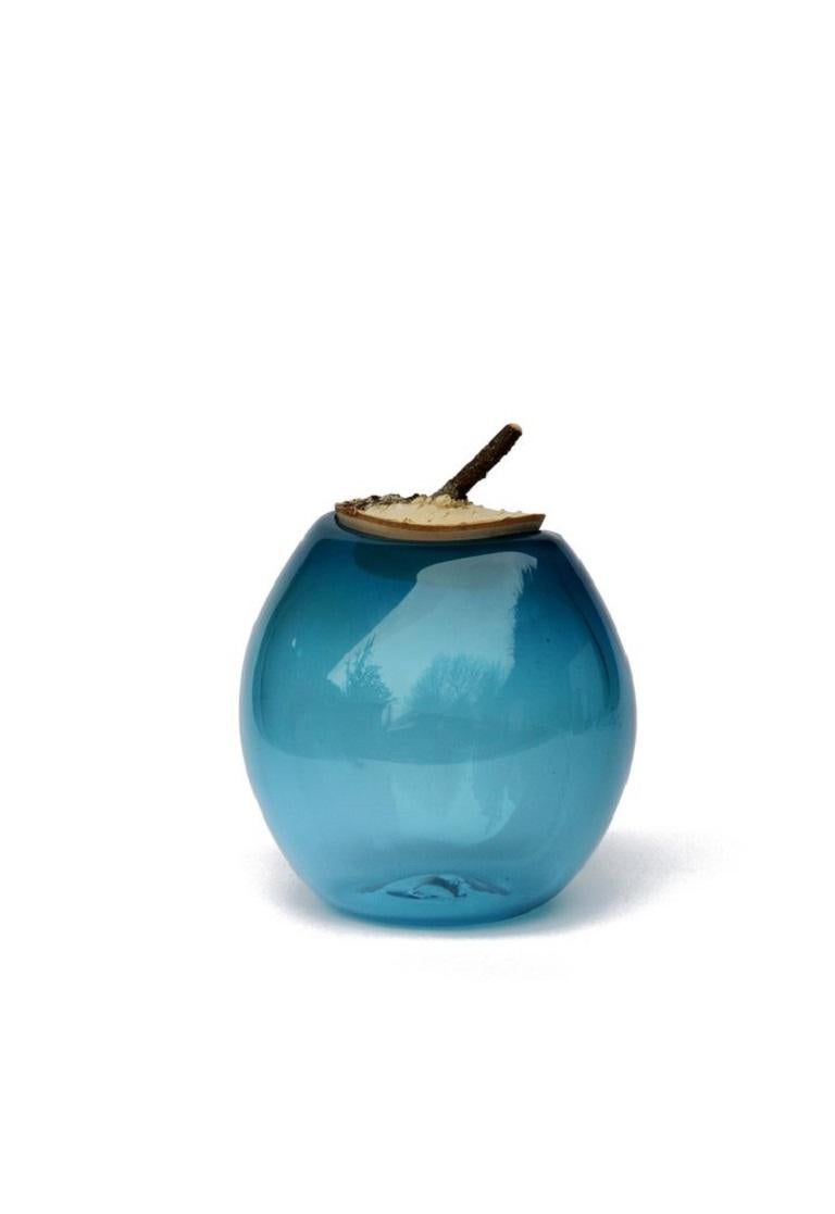 Aqua branch bowl, Pia Wüstenberg
Dimensions: D 16-18 x H 20
Materials: glass, wood
Available in other colors.

A playful jar, with a lid made from a branch stub following the curvature of the glass. Branch Bowls are blown without a mould: their