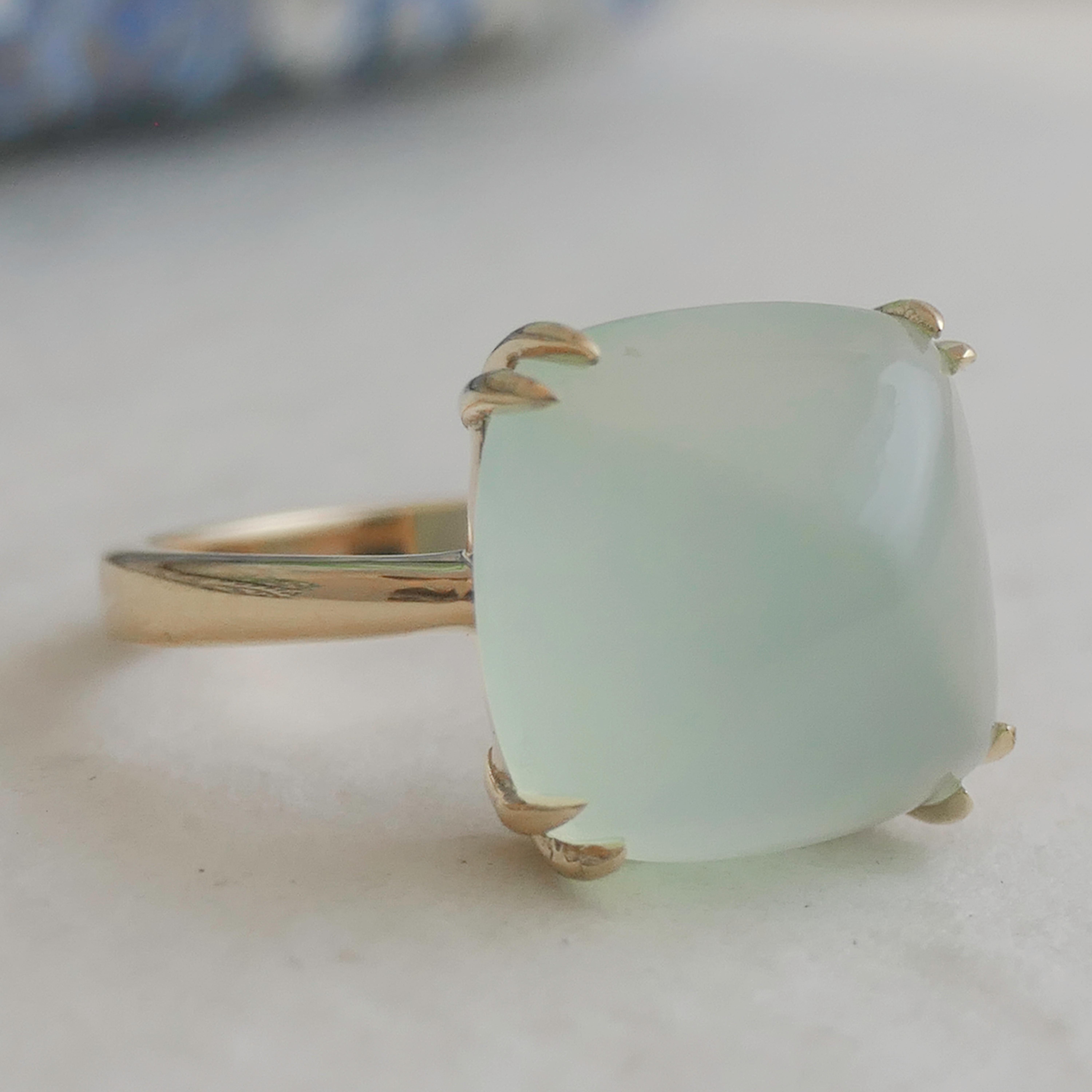 Features a 12x12mm Sugar Loaf cut Aqua Chalcedony gemstone, expertly prong-set in high-quality gold plated sterling silver.
Handcrafted with attention to detail, ensuring a unique and exquisite piece of jewelry.
The rich aqua  hue of the chalcedony