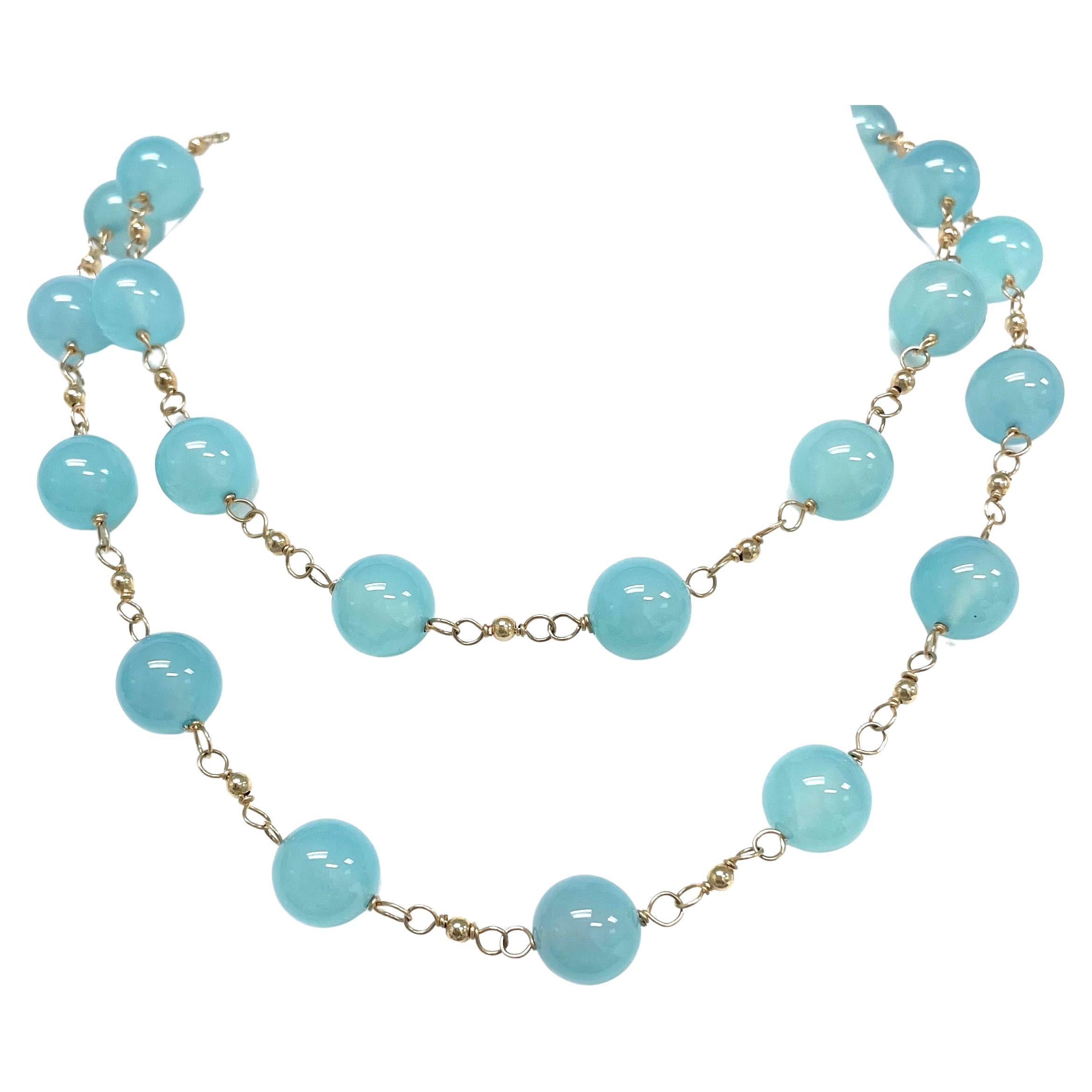 Description
Beautiful, vivid and calming Aqua Chalcedony (AAA quality), individually wire wrapped and accented with small yellow gold-filled balls to create an overall harmonious and feminine style. The necklace can be worn long or short when