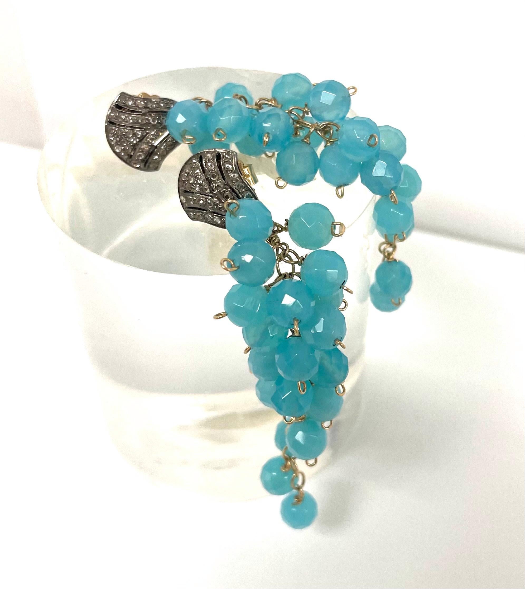 Description
Beautiful, vivid and calming Aqua Chalcedony individually wire wrapped creating a cascading cluster, crowned with pave diamond studs for an overall harmonious and feminine style.
Item # E2955
To make a statement, pair it with necklace