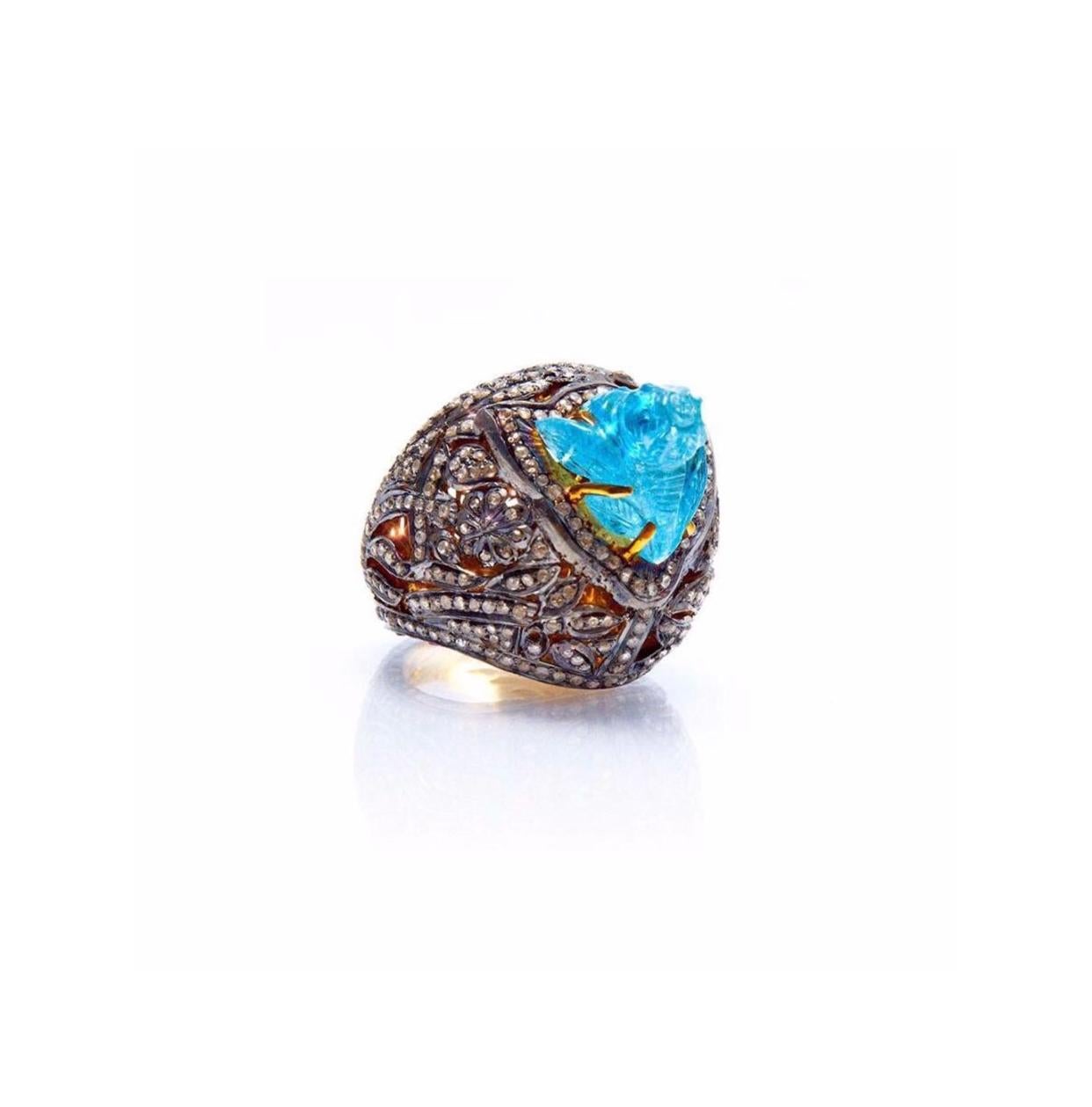 “Aqua Flora”... A vibrant Cabochon Aquamarine flower dramatically set upon a large filigree dome of sparkling White Diamonds in a fabulous Blackened Silver cocktail ring with a contrasting 18 Karat Gold interior.

- Natural Aquamarine weight approx