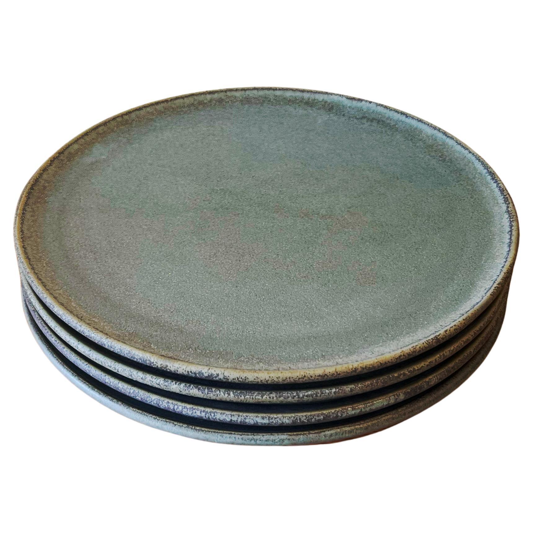 Aqua ceramic dinner plates, set of 4.

For those that want a show stopping dinner set, these dreamy aqua dinner plates are the perfect decor item to add to your collection. The organic blue green surface of these elegant dinner plates has a subtle