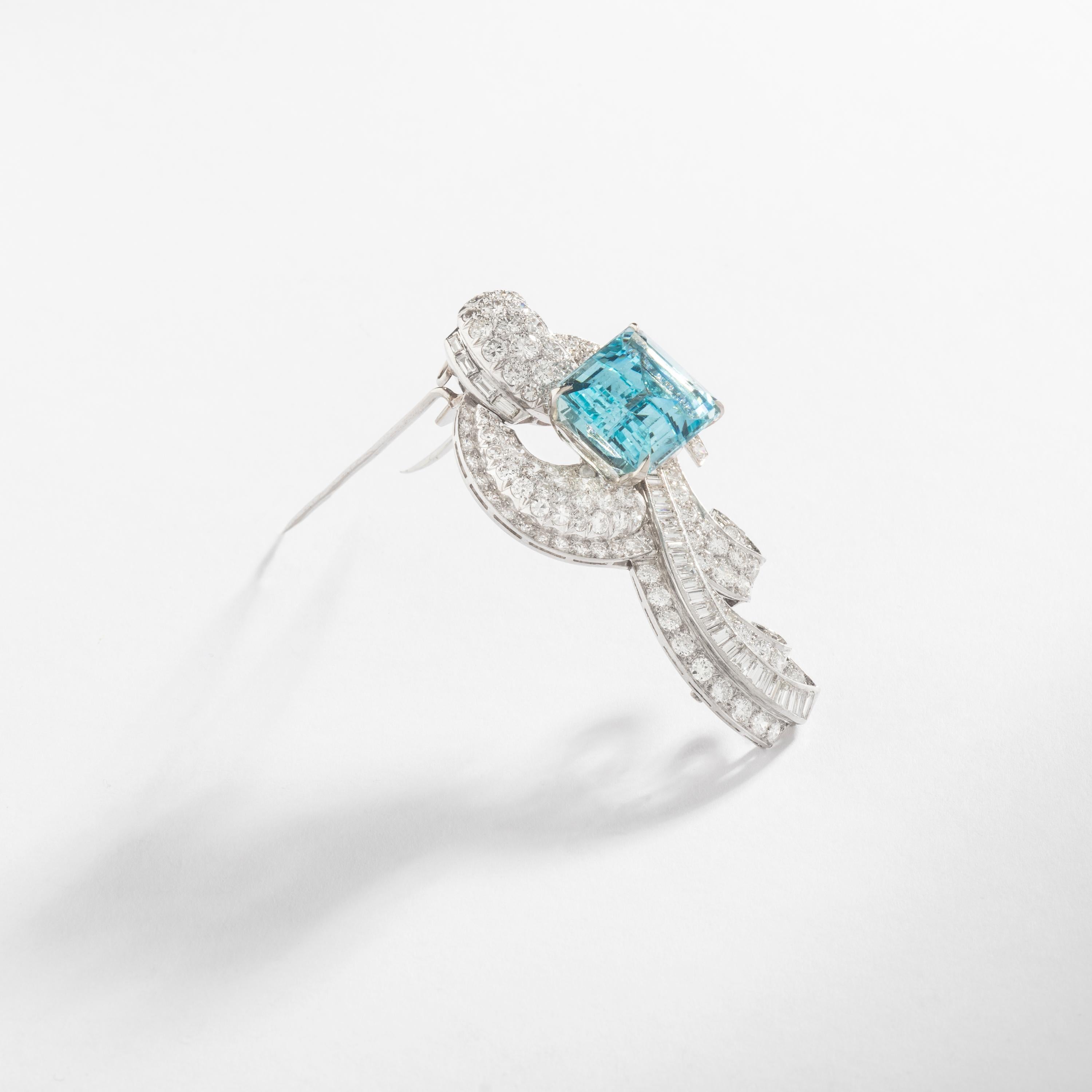 Aquamarine (approximately 17.50 carats) on a Round and Baguette cut Diamond (approximately 5.00 carats) Platinum Brooch convertible in Pendant.

Circa 1935.
Total length: 2.36 inches (6.00 centimeters).

