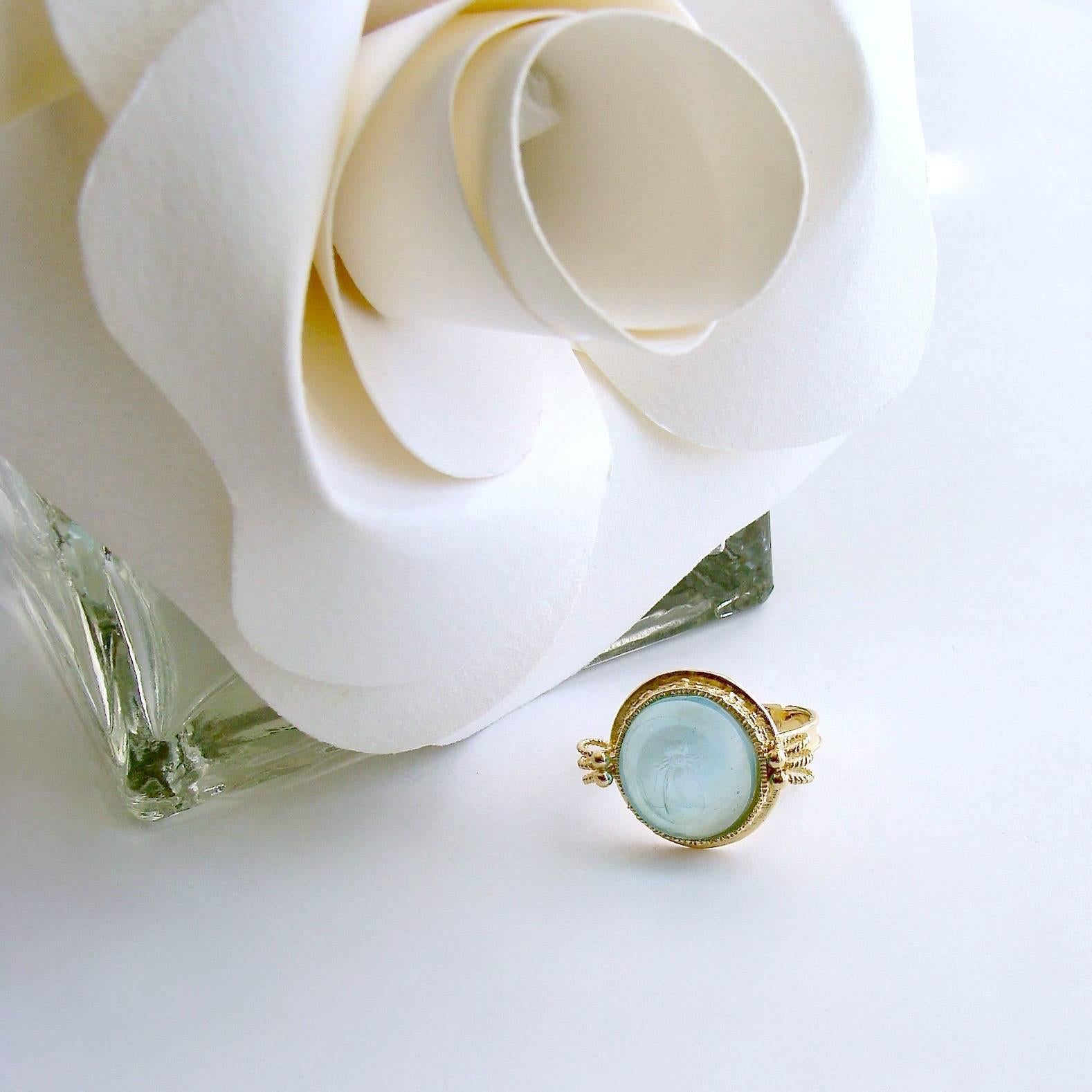 Peu d’Abelle Aqua Ring.

A dainty gorgeous soft aqua Venetian glass intaglio of a Napoleonic bee is the focal point of the charming ring.  This classic work of art has been backed with mother-of-pearl and is set in timeless neoclassical gold vermeil