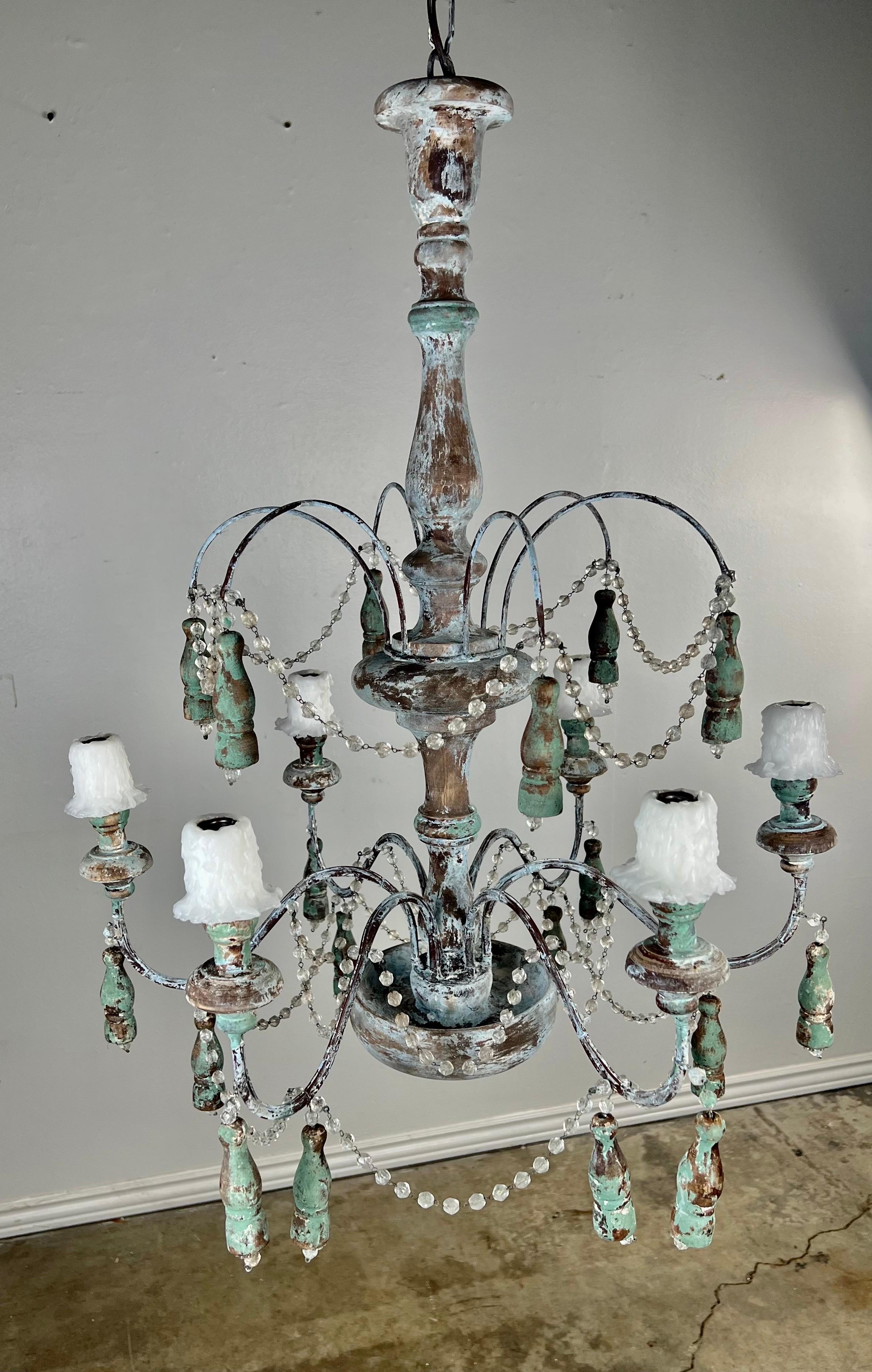 6-Light Chandelier with iron & wood tassel drops throughout.  There are only remnants of paint left on the fixture in a stunning green/blue coloration.  There are garlands of English Cut Beads.  The chandelier is newly wired and includes chain &