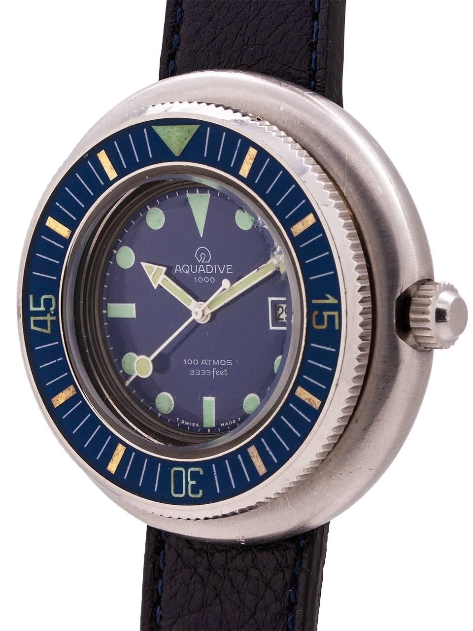 
Vintage circa late 1960’s Swiss Aquadive. Featuring a large and thick 50mm “saucer shaped” stainless steel case with a wide stepped up, blue bakelite elapsed time bezel. Featuring a mineral glass crystal, and great condition dark blue original dial