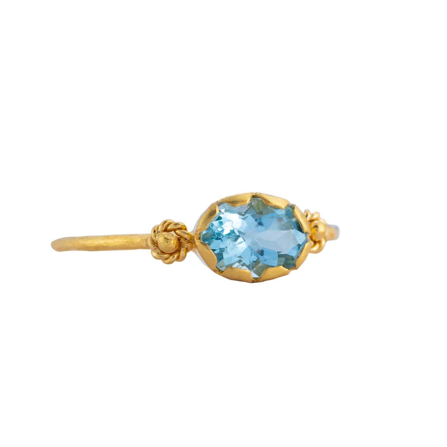 This lovely one-of-a-kind 14ct gold aquamarine stacking ring has been handmade in our workshops. It is embedded with an aquamarine which is flanked by embossed work. Wear it on it's own or stacked, whatever your preference.

Ring dimensions -