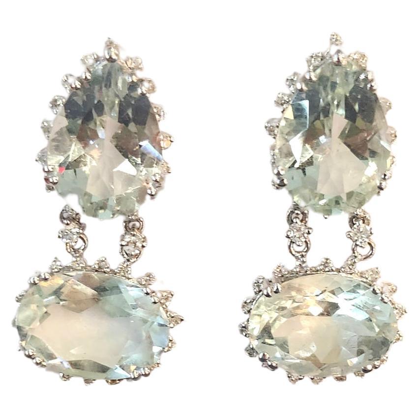 18k white gold earrings centered and topped with 4 large oval natural aquamarine in pale blue color with estimate weight 18 carats flanked with brilliant cut diamonds earrings lenght 4.5 cm made in europe 