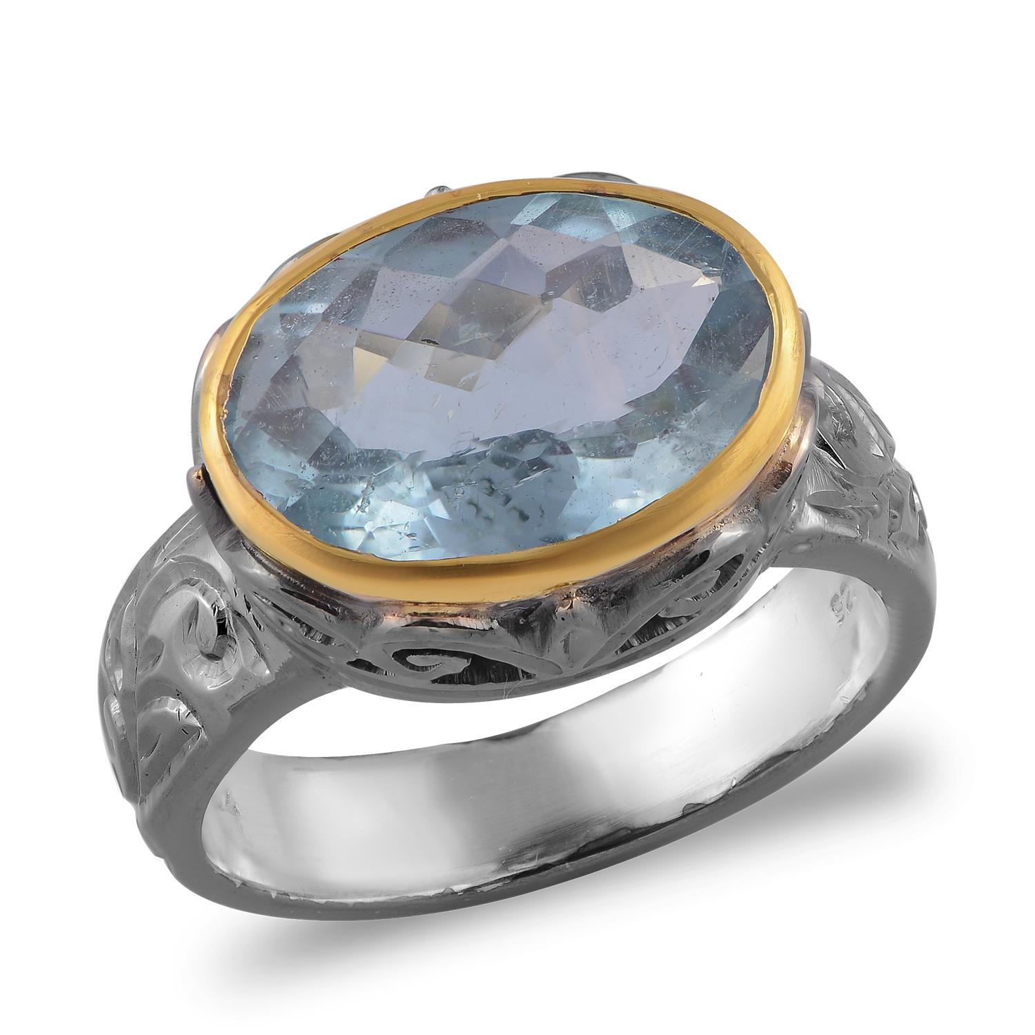 

This gorgeous one of kind ring has been handmade in our workshops. It features a stunning aquamarine, encased in 18ct gold and set on jaali work.  The shank, which is made of sterling silver is hand engraved and is oxidized.

Dimensions - 15mm x
