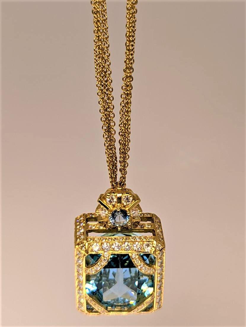 Surrounded by an 18k yellow gold frame, this Aquamarine weighing 46.46 cts contains 202 Diamonds weighing 4.82 cts.  The bail houses a 5mm Aquamarine that serves as the center point of the motif.  In what may be the richest Aquamarine that we have