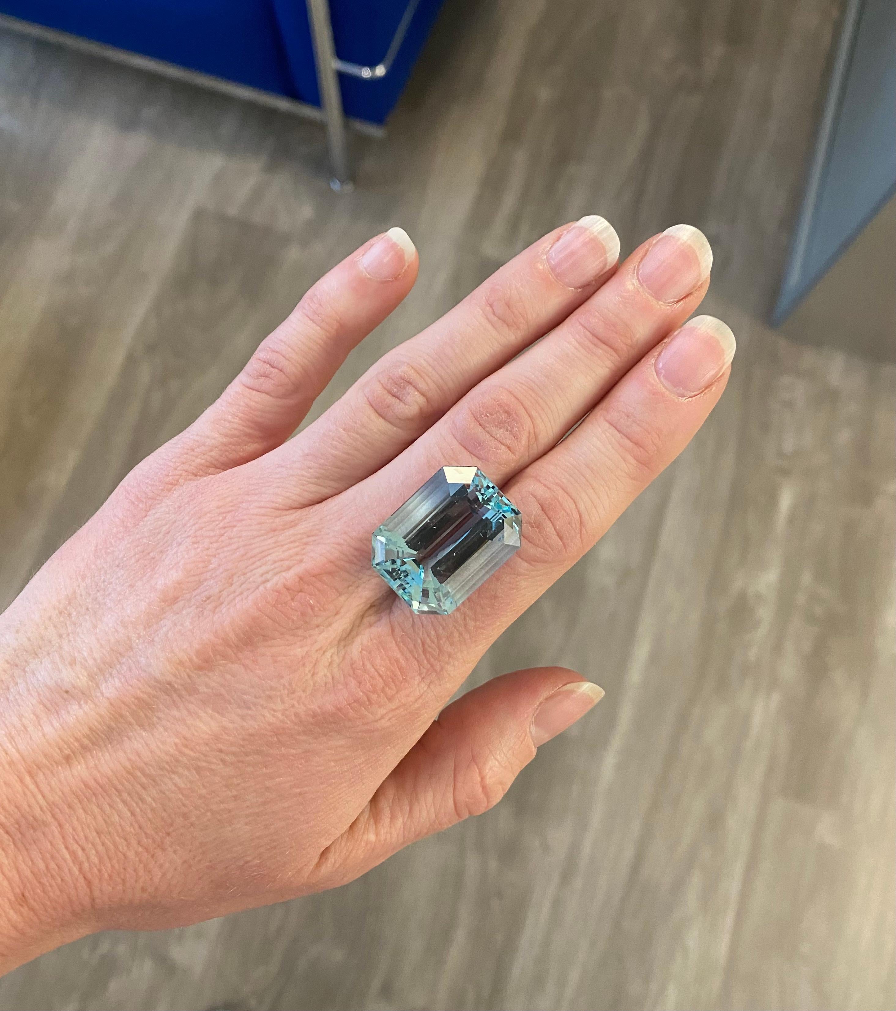 A beautiful emerald cut light blue aquamarine weighing 49.54ct. This stone has been cut in Geneva, and its facets and symmetry are stunning and compliment the beautiful light colour.