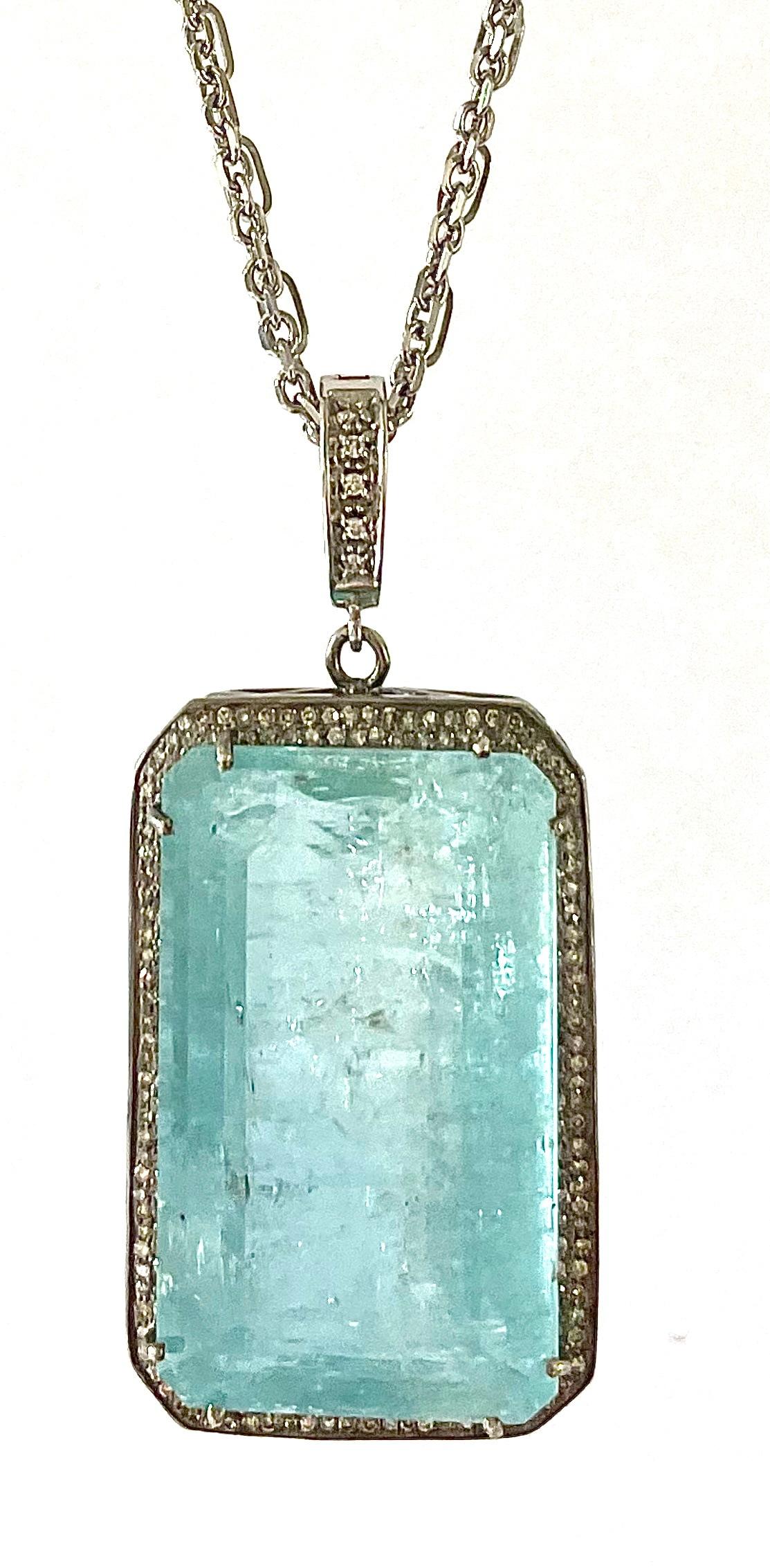 Description
Stunning and unique, large 76 carat Aquamarine pendant with natural character inclusions and pave diamonds. 
Pendant suspends from a double 14k white gold chain necklace. Pendant is removable, but not sold separately.
Item #