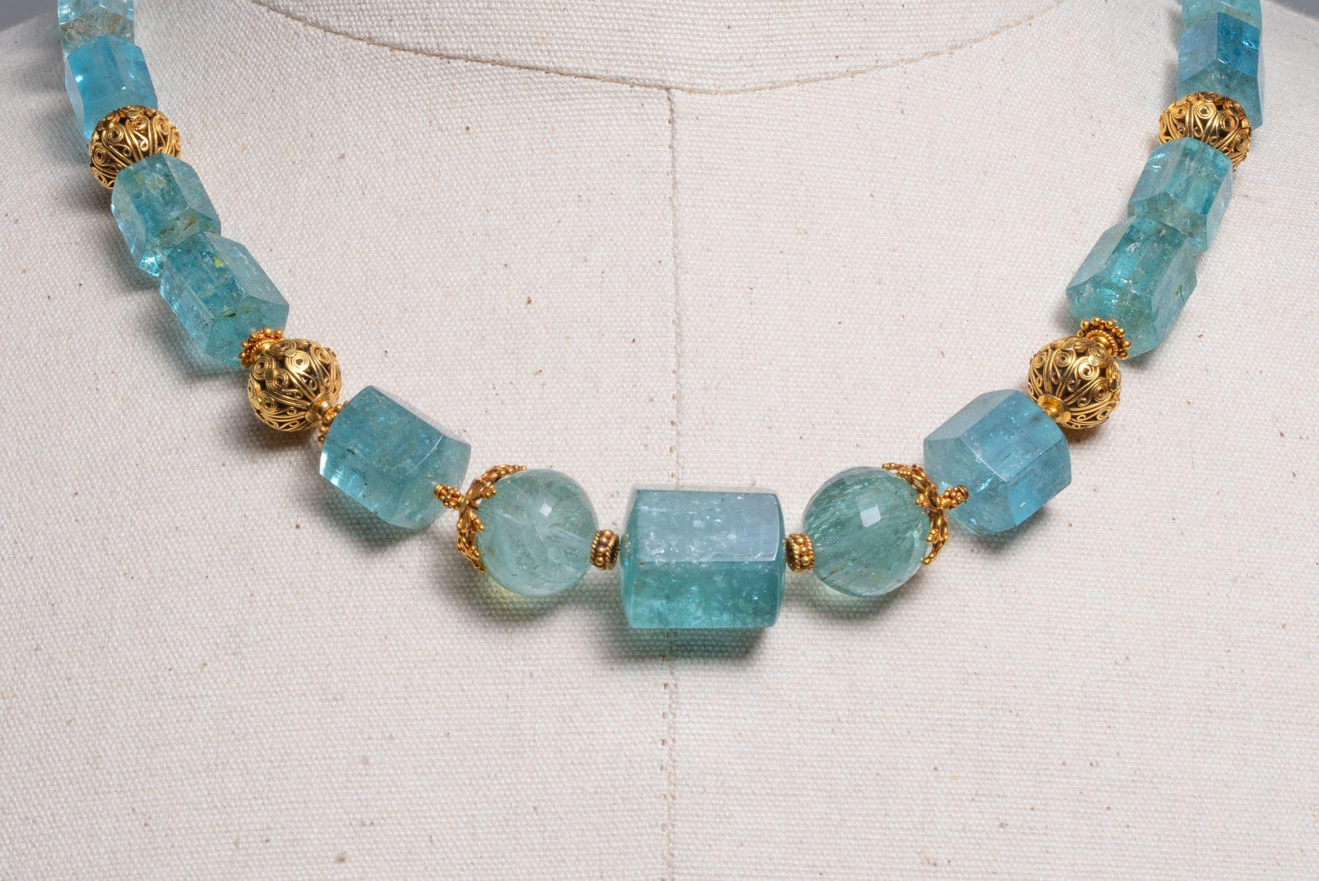 A stunning aquamarine beaded necklace with 18K gold.  The large aquamarines are a combination of beveled and faceted round beads of exceptional color and translucence.  The gold beads are all hand crafted with wire work and granulation in 18K gold. 