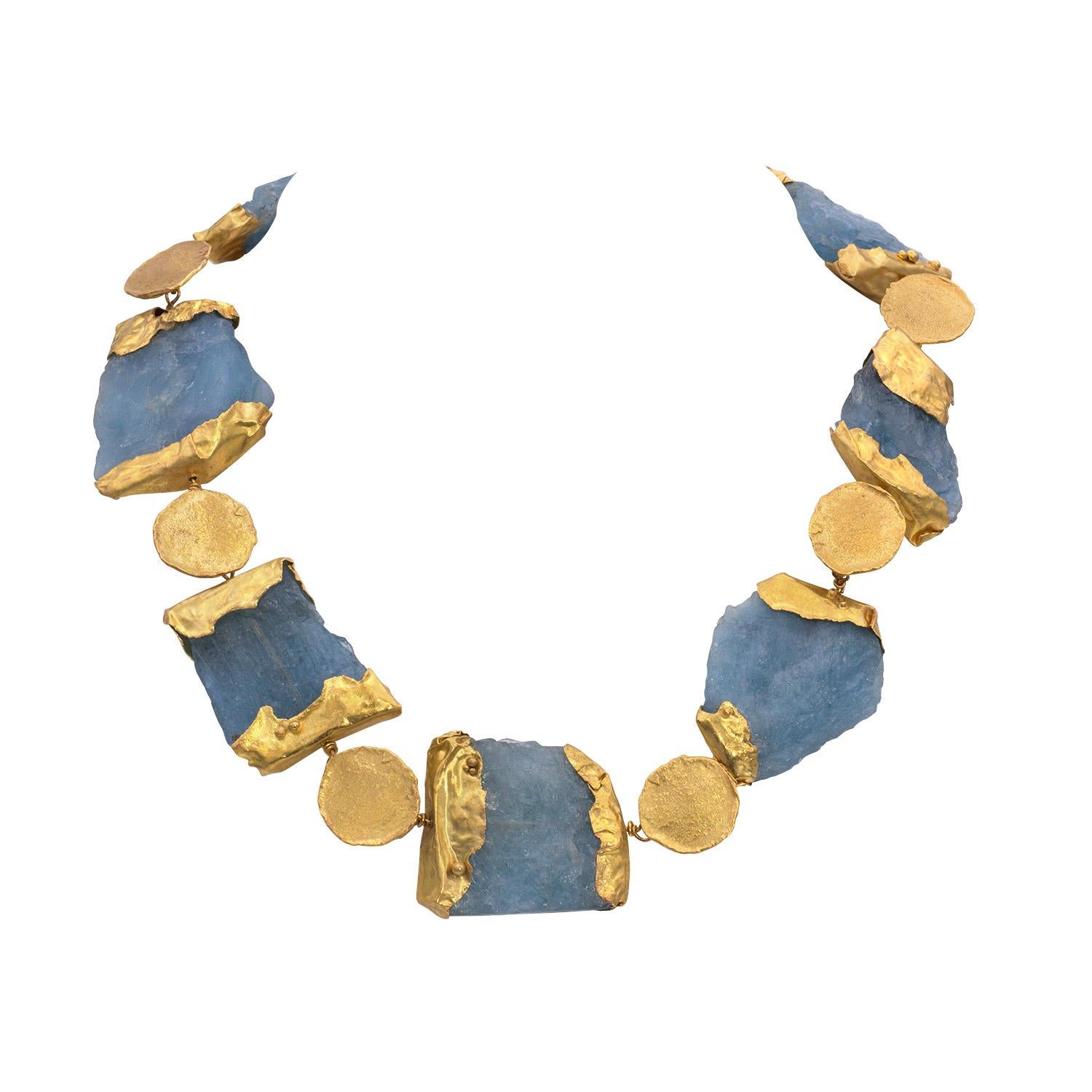 Designed as a series of rough aquamarine crystals embellished with handmade 22K gold caps. This necklace was entirely handmade in New York City by the studio jeweler Tess Sholom. The necklace looks ancient and rich, as if it was excavated at an