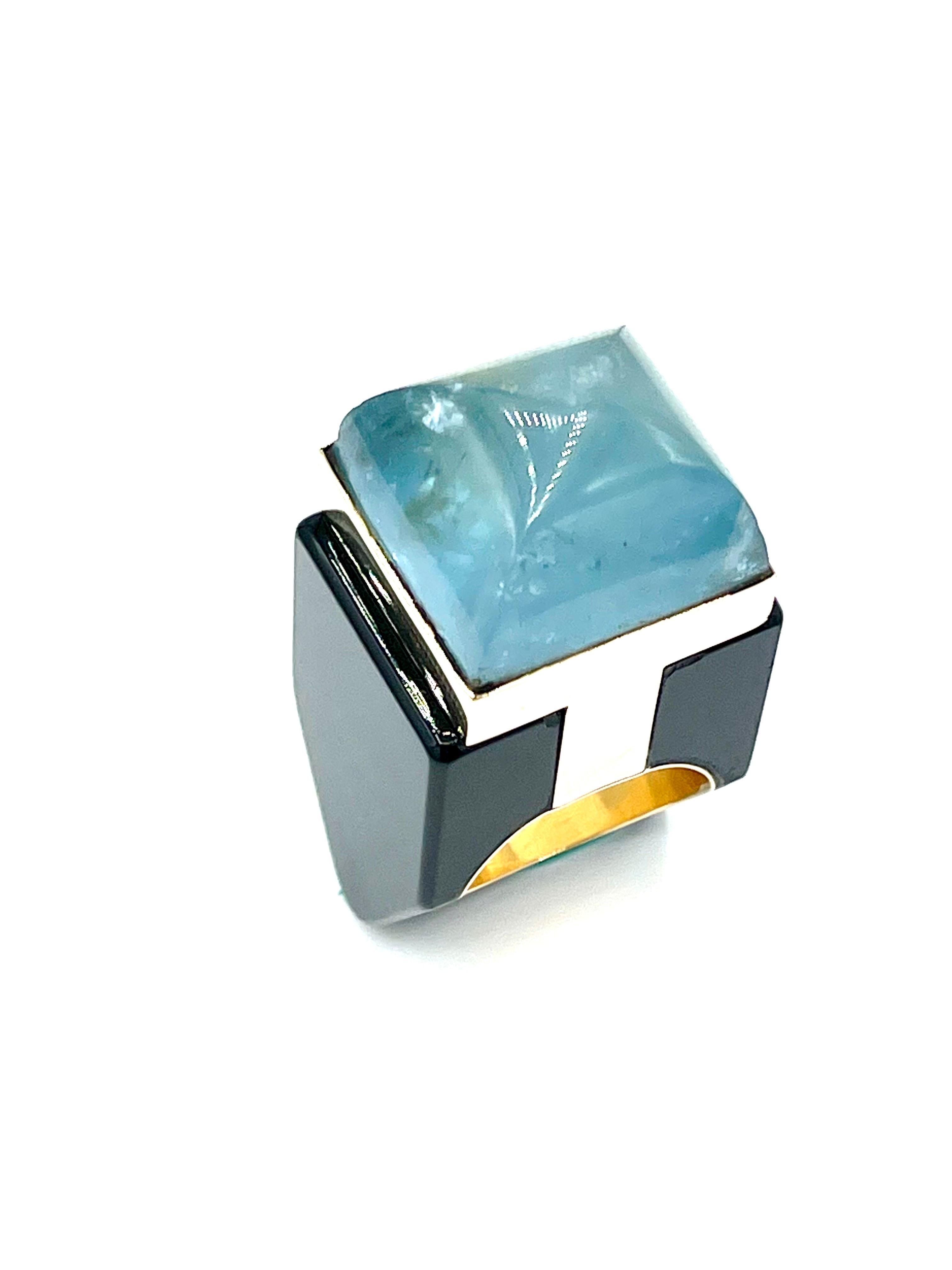 A fun and eye catching cocktail ring!  The cabochon Aquamarine is bezel set atop a wide shank made from black Onyx and 18K yellow gold.  The ring is two inches from top to bottom.  It is currently a size 7.00 and can not be adjusted.  Offered by