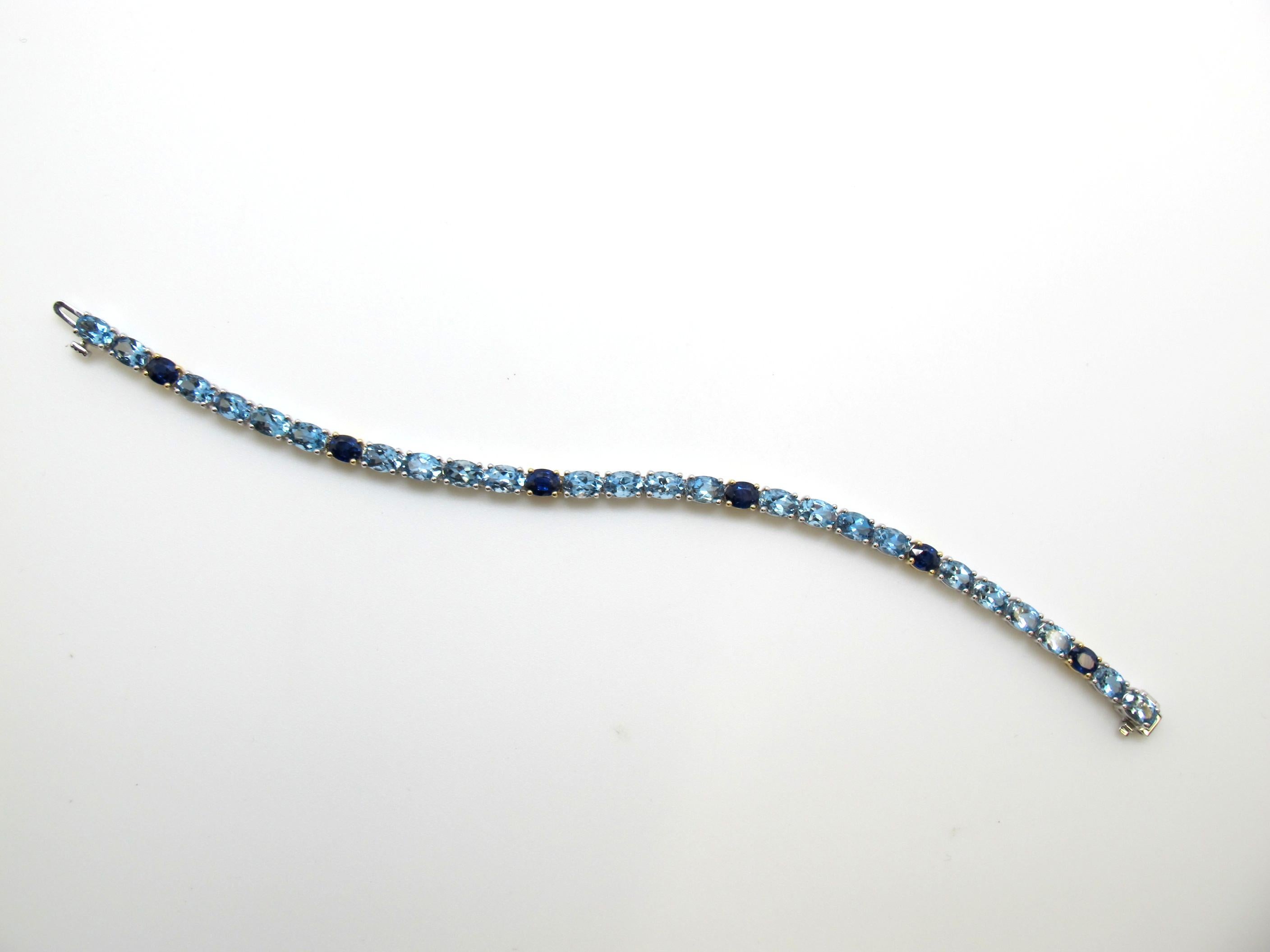 There is no denying how dazzling this piece is! The incredibly vibrant 24 aquamarine stones, measuring 6X4mm 10.26 carats total weight, and the six vivid blue sapphires, measuring 4X5mm 3.31 carats total weight make this bracelet truly one of a