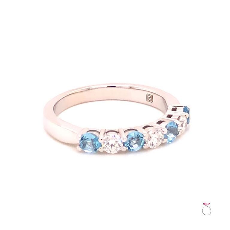 Beautiful Designer Diamond  and Aquamarine band ring in 14k white gold. The band features seven stones, 3 diamonds and 4 Aquamarine. The diamonds and the Aquamarine measure 3 mm each, approximately 0.10 carsts for a total diamond weight of 0.30