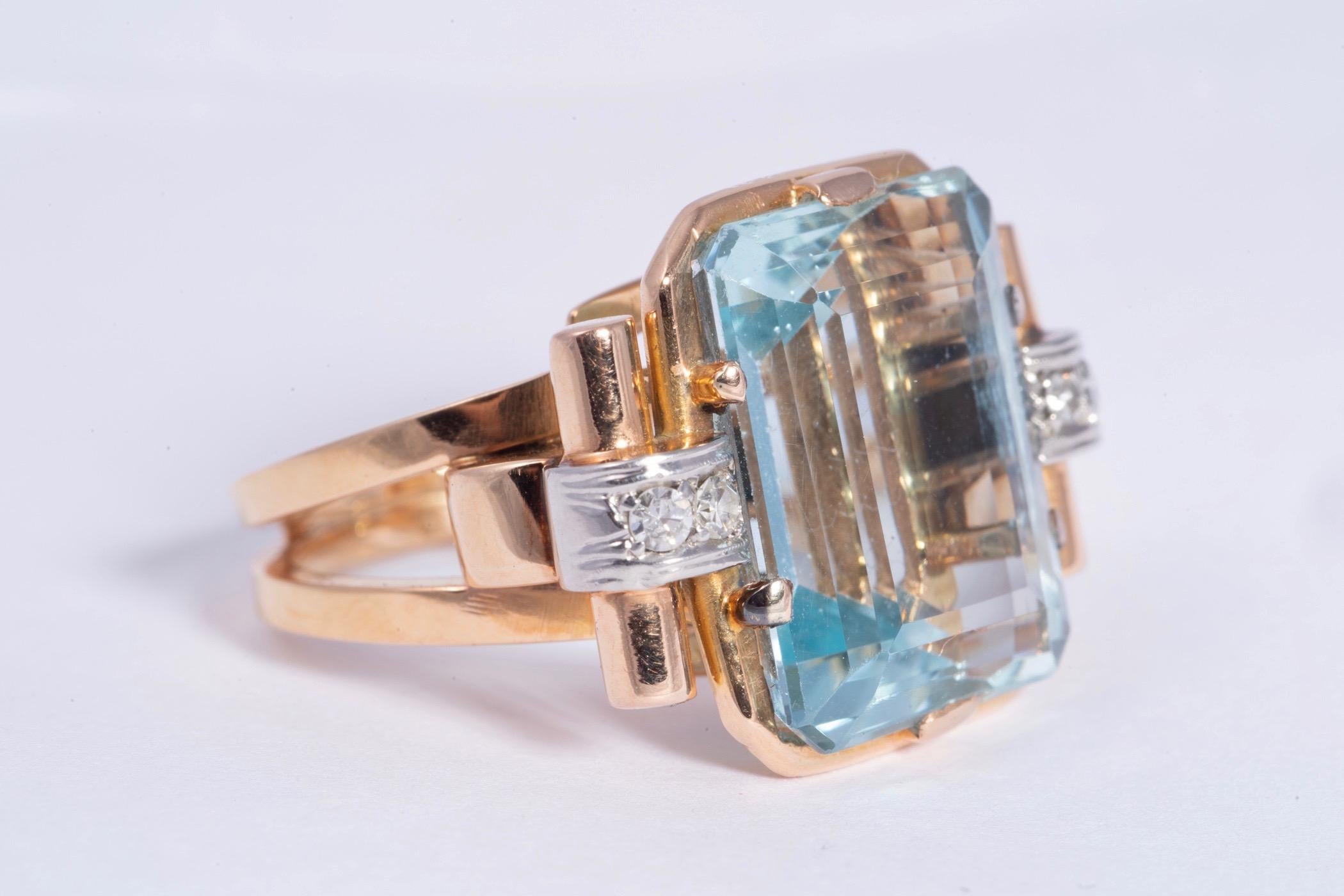 Magnificent aquamarine and diamond period art deco ring. The center aquamarine measures 16.50x13.20x8.10mm and weighs approximately 12.00cts. The stone has excellent clarity and pale blue color There are two single cut diamonds on either side of the