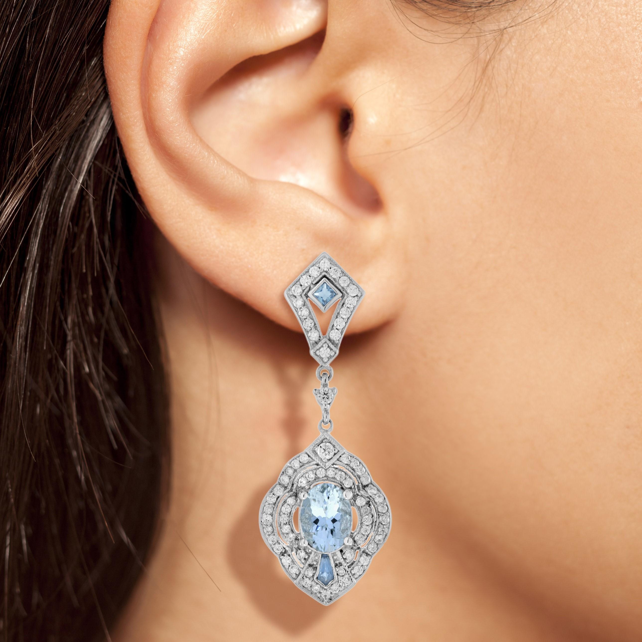 One of the most magnificent pair of aquamarine and diamond drop earrings from the Art Deco era inspiration. Exquisitely hand made in white gold, each earring is set with an approx. 3 carat oval shape aquamarine that stands out against both the