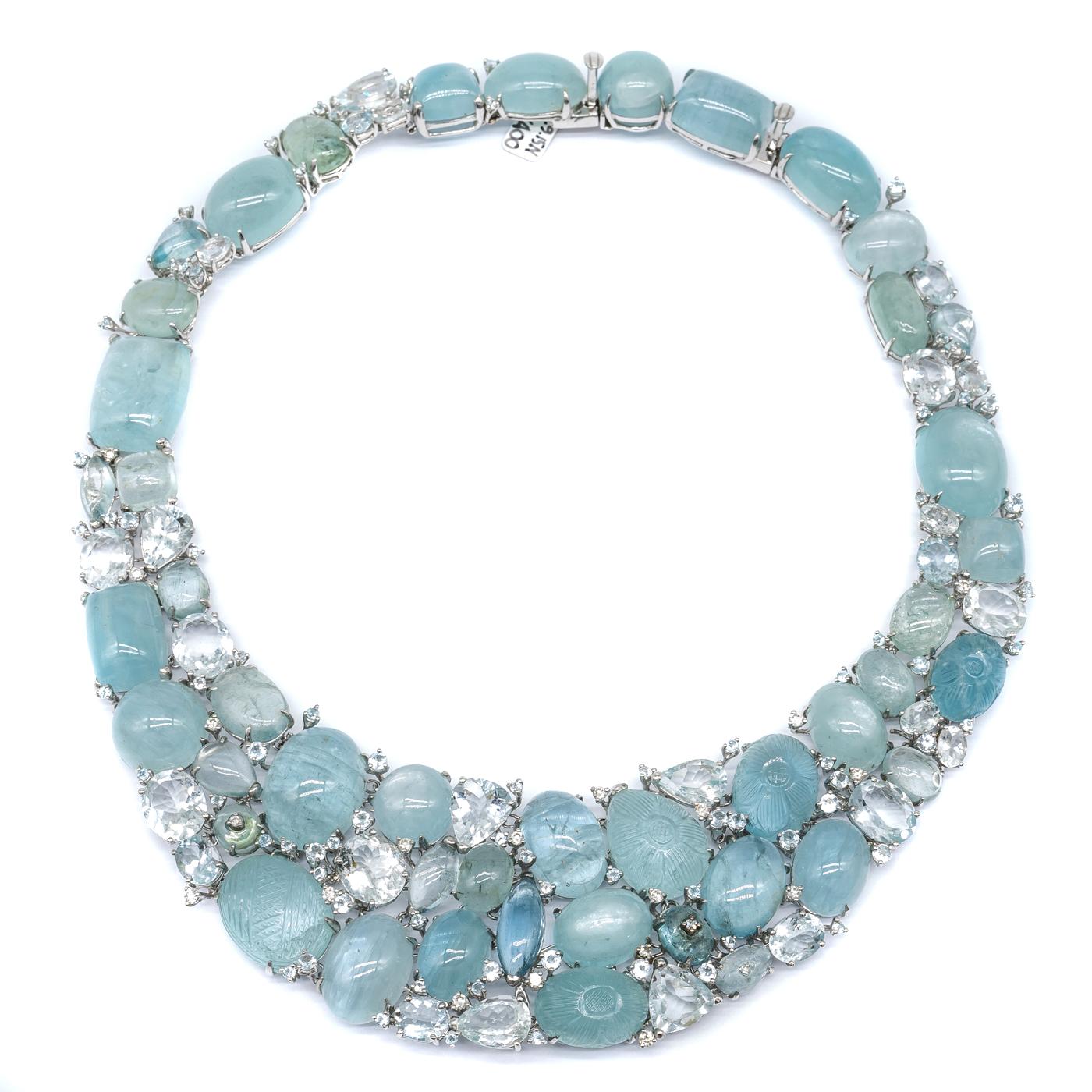 A Moira Design, fine, multi stone aquamarine necklace, set with mixed cuts of faceted and cabochon aquamarines, weighing an estimated total of 560.00ct, with 1.13ct of round brilliant-cut diamonds, mounted in 18ct white gold. With a push-in tongue