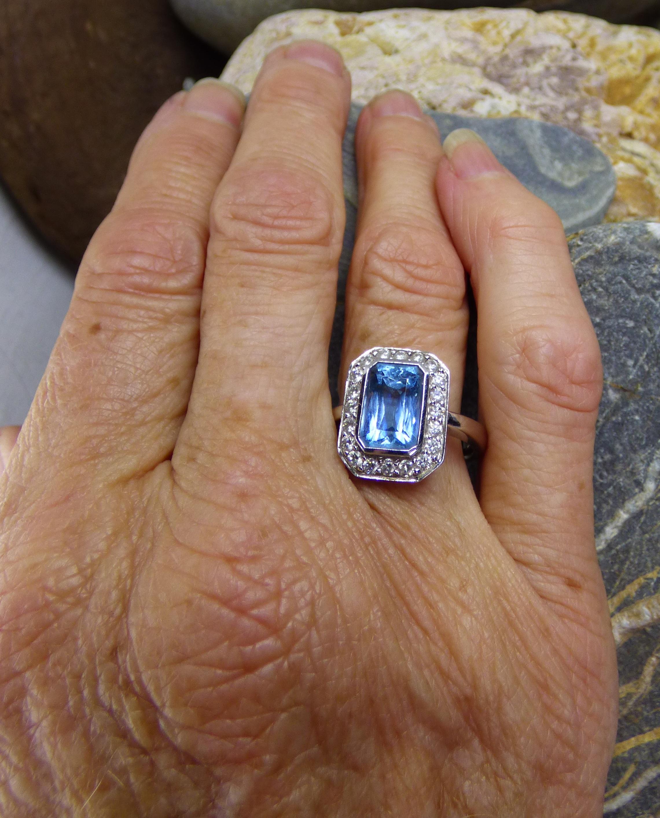 An Aquamarine and Diamond ring. The total size of the cluster is 15X12mm. The Aquamarine is 3.05ct surrounded by 20 Diamonds (.57ct.). The ring is handmade in 18K white gold.