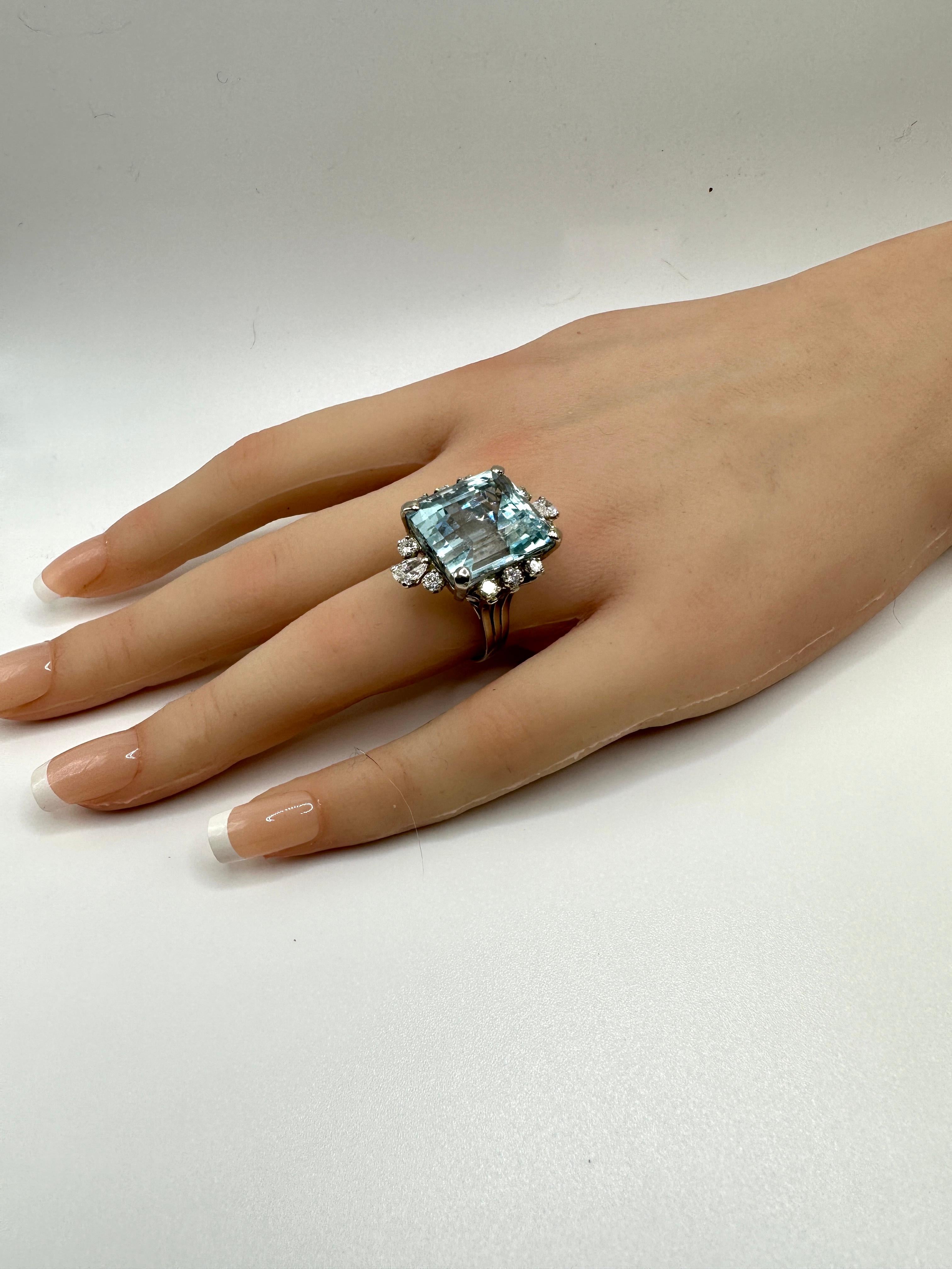  Dazzling Cocktail ring!  20.83 carat Emerald cut aquamarine set in 14k white gold.  Surrounded  by two pear shape brilliant cut Diamond on top and bottom along with 10 round brilliant diamonds totaling 1.38 carats.  Total weight 10.60g.  In
