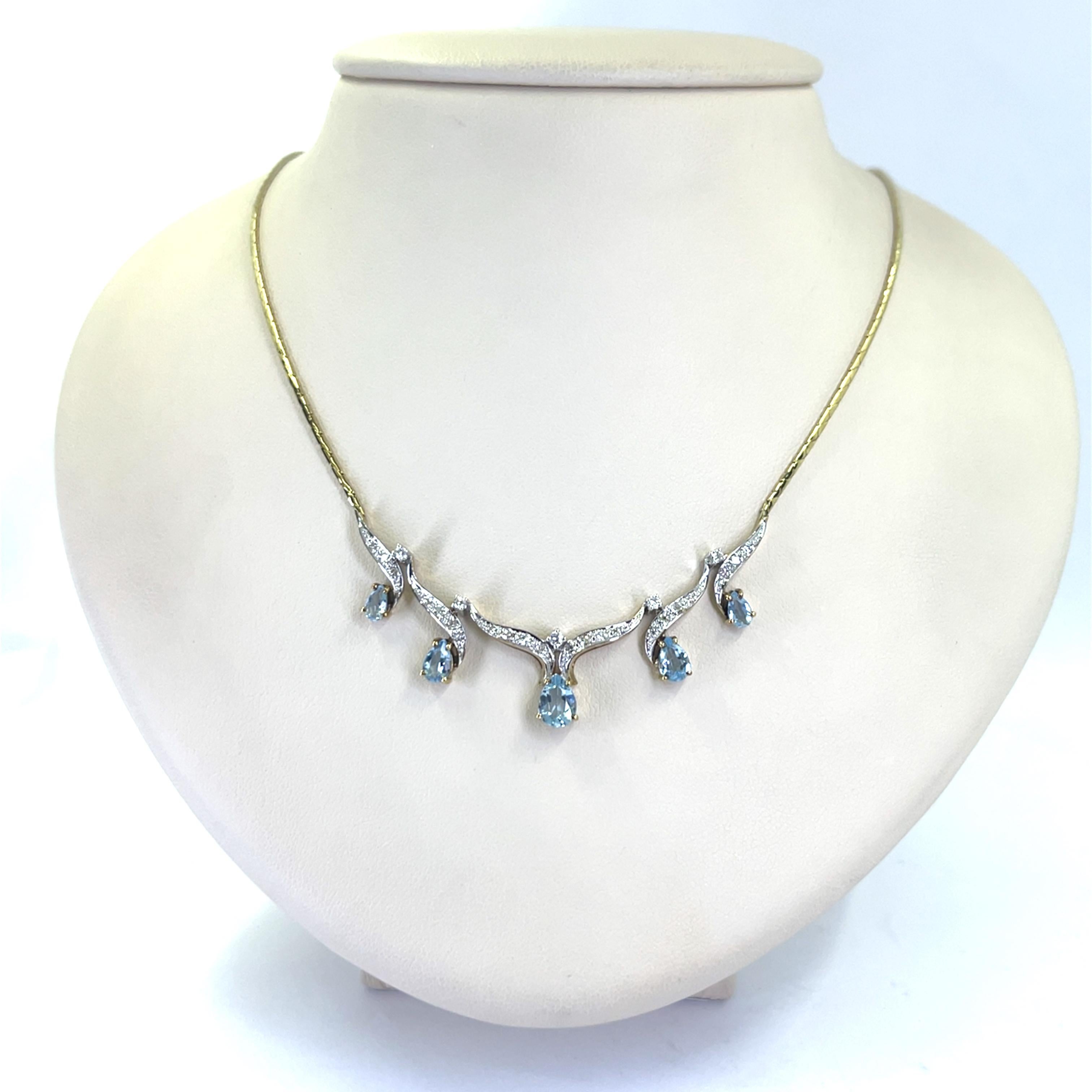 14 karat yellow gold collar necklace featuring 5 oval and pear cut aquamarines totaling approximately 1.00 carat accented by 27 round diamonds of VS clarity and H color totaling 0.25 carats. 16 inches long with box clasp and figure 8 safety.