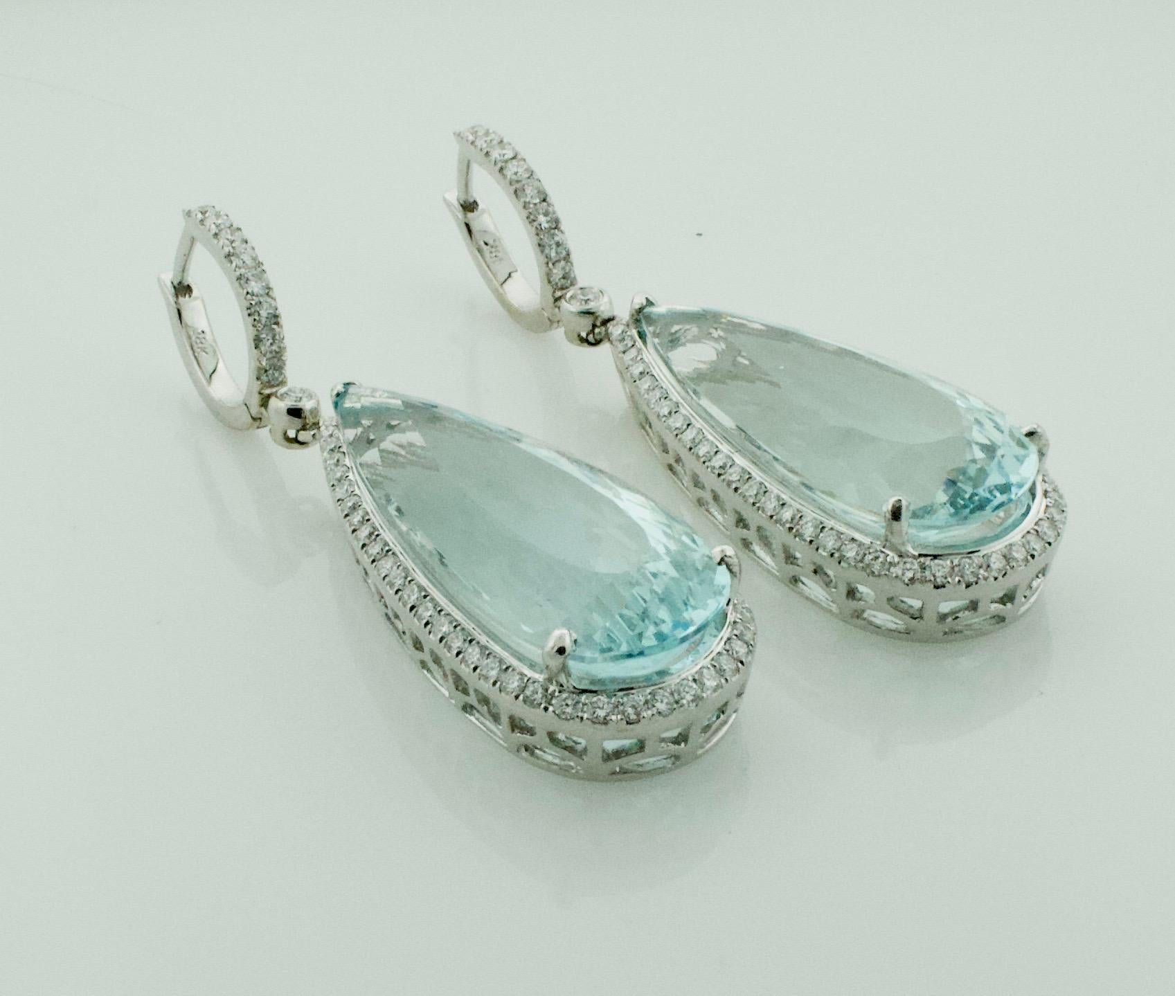 Aquamarine and Diamond Dangling Drop Earrings in 18k White Gold 
2 Pear Shape Cut Aquamarines Weighing 30.00 Carats Approximately 
125 Round Brilliant Cut Diamonds Weighing 1.50 Carats Approximately 
Aquamarine and Diamond Dangling Drop Earrings in