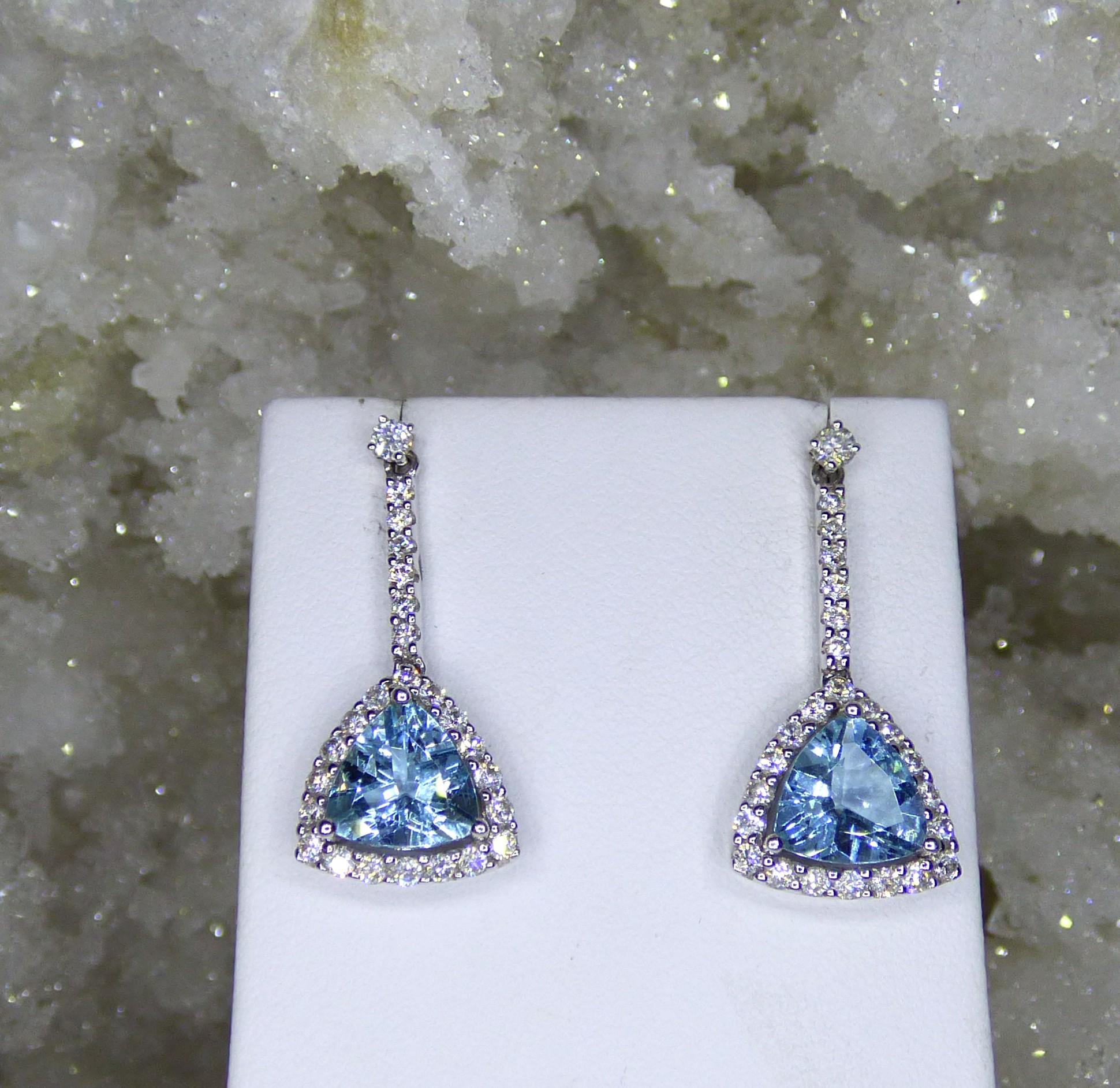 Bright clean colourful Triangular shaped Aquamarines 8X8mm (2.81 total carat weight) drop from .06ct Diamond studs. There is a further 48 Diamonds dropping down and surrounding the Aquamarines with a total Diamond weight of .86 ct.  The earrings are