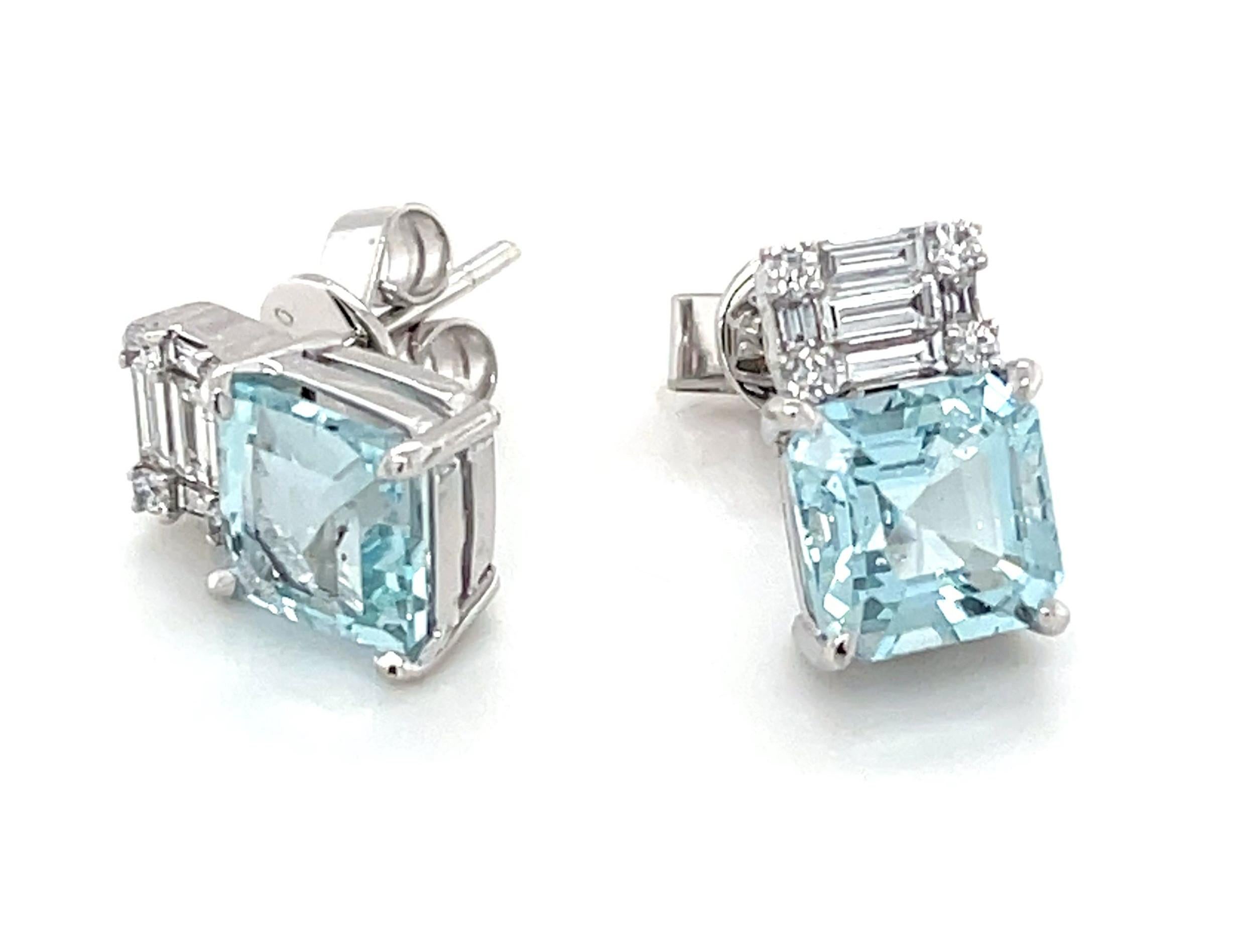 These eye-catching earrings feature stunning, square emerald-cut aquamarines set in 18k white gold and topped with a beautiful arrangement of baguette and round brilliant cut diamonds! The bright crystalline aquamarine have gorgeous blue color and