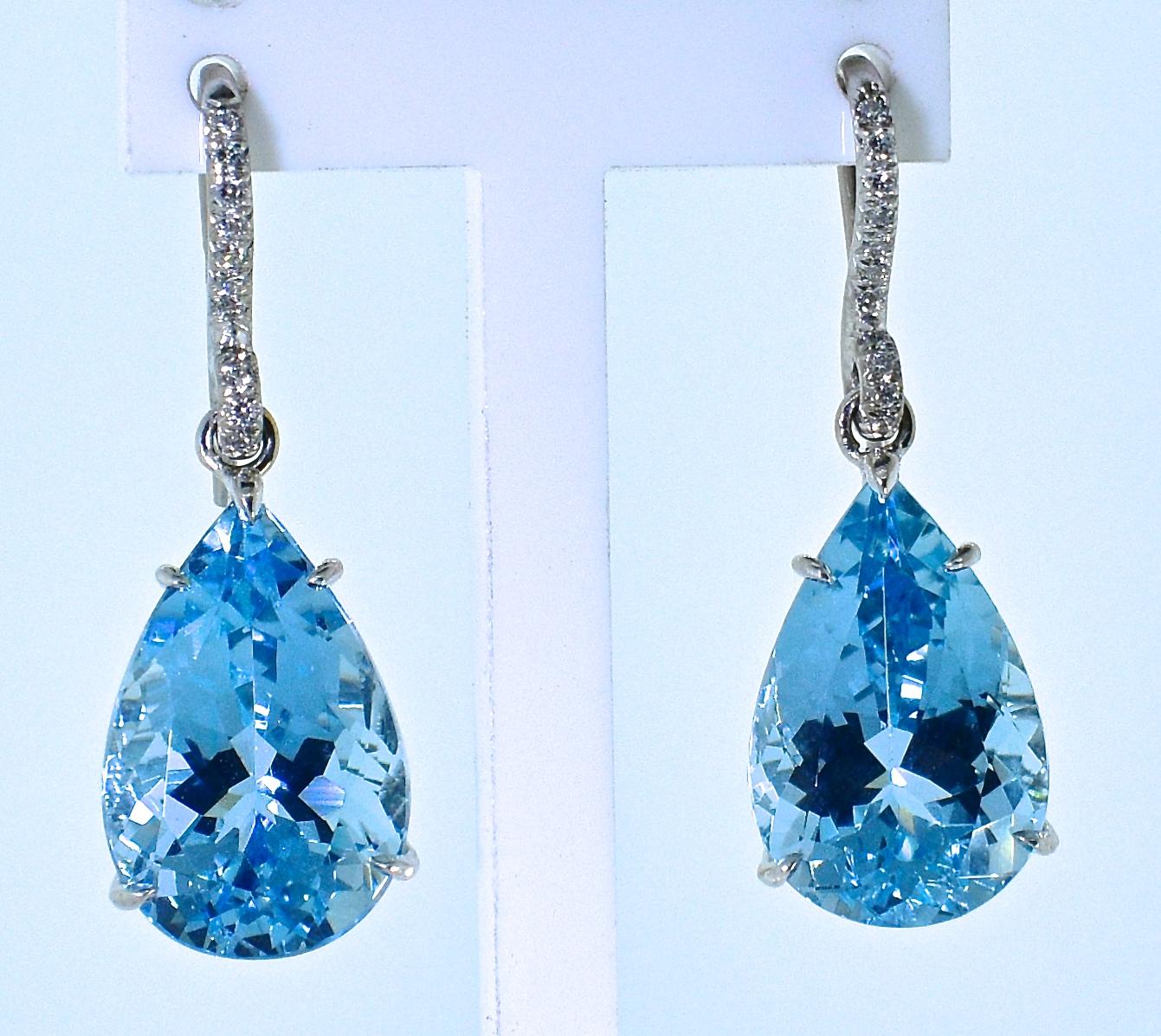 Aquamarine and fine diamond pendant style earrings hand made in 18K white gold with approximately 16 cts. of fine pear cut natural aquamarines.  These well matched and well cut stones with 22 small brilliant cut white diamonds.  These earrings are