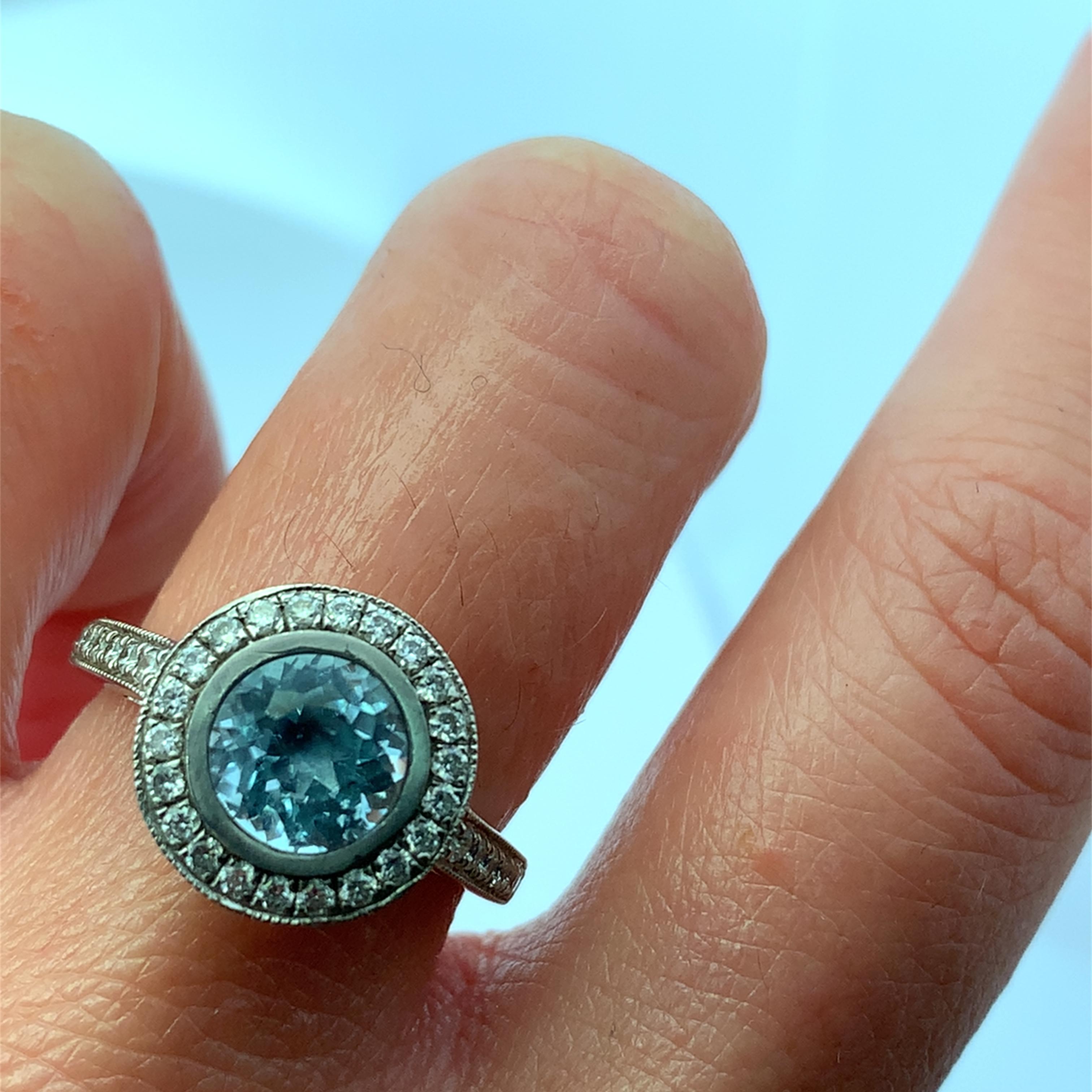 Discover the allure of this stunning blue aquamarine gemstone ring, featuring a captivating center blue aquamarine 1.80ct stone surrounded by a halo of sparkling diamonds 1.50ct G VS1. Crafted with precision, this piece is perfect for adding a touch
