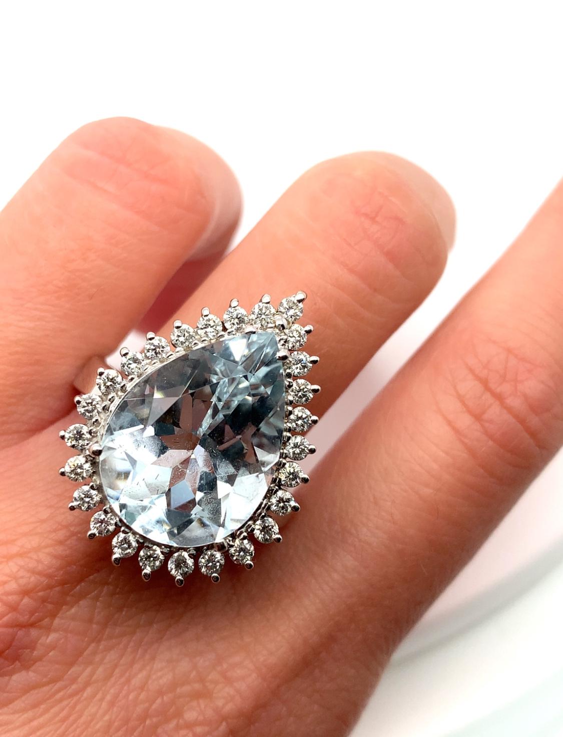 11.68ct Aquamarine Pear shape and diamonds engagement cocktail ring in 18k gold.

Gorgeous large Aquamarine gemstone light blue vivid colour with diamond halo cluster pear shaped gemstone, natural untreated heavy weight in 18ct white gold.

Chunky