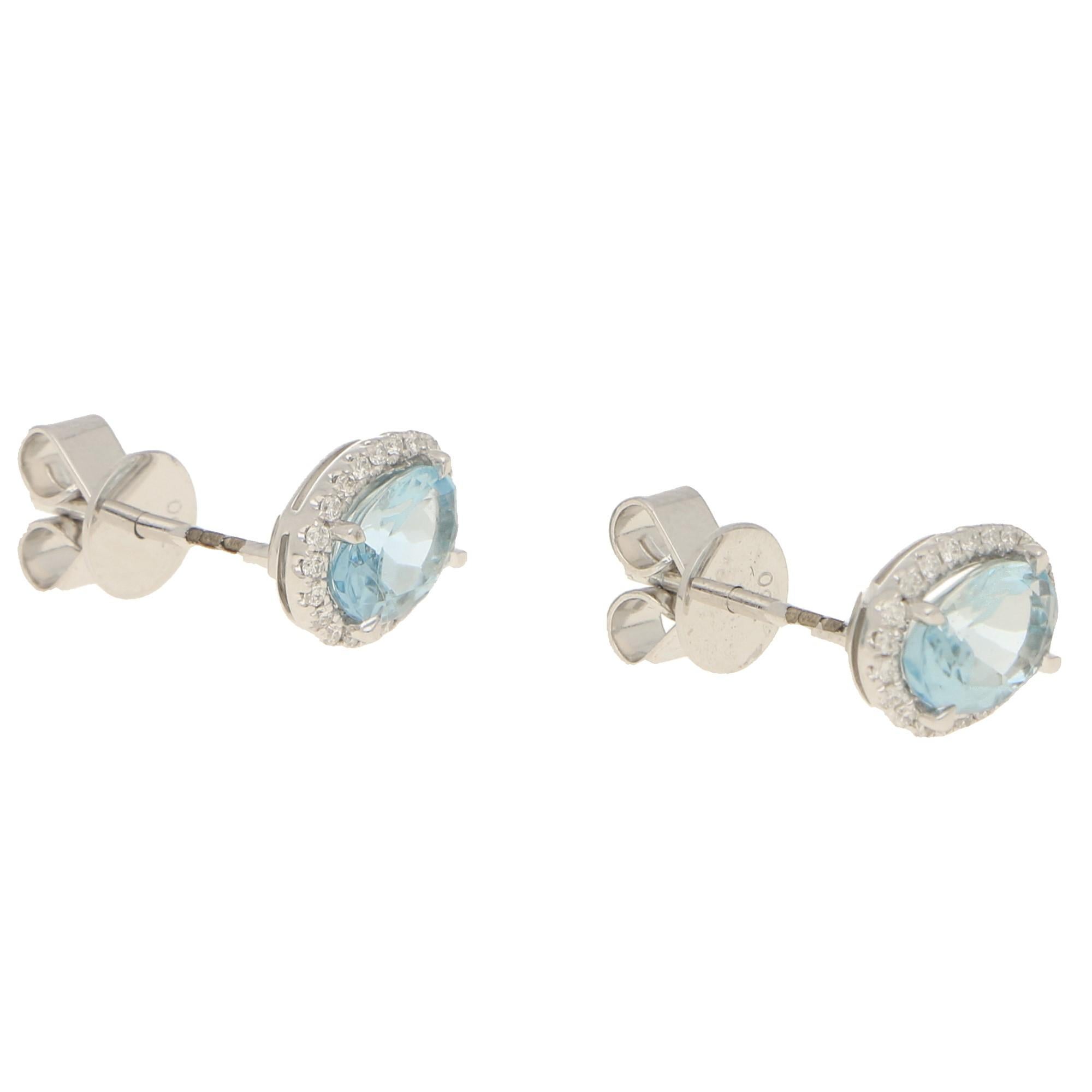 A beautiful pair of aquamarine and diamond cluster stud earrings set in 18k white gold! 

The earrings are prominently set with oval shaped aquamarines which are subtly four claw set to the centre.  There is a total aquamarine weight of 1.38 carats