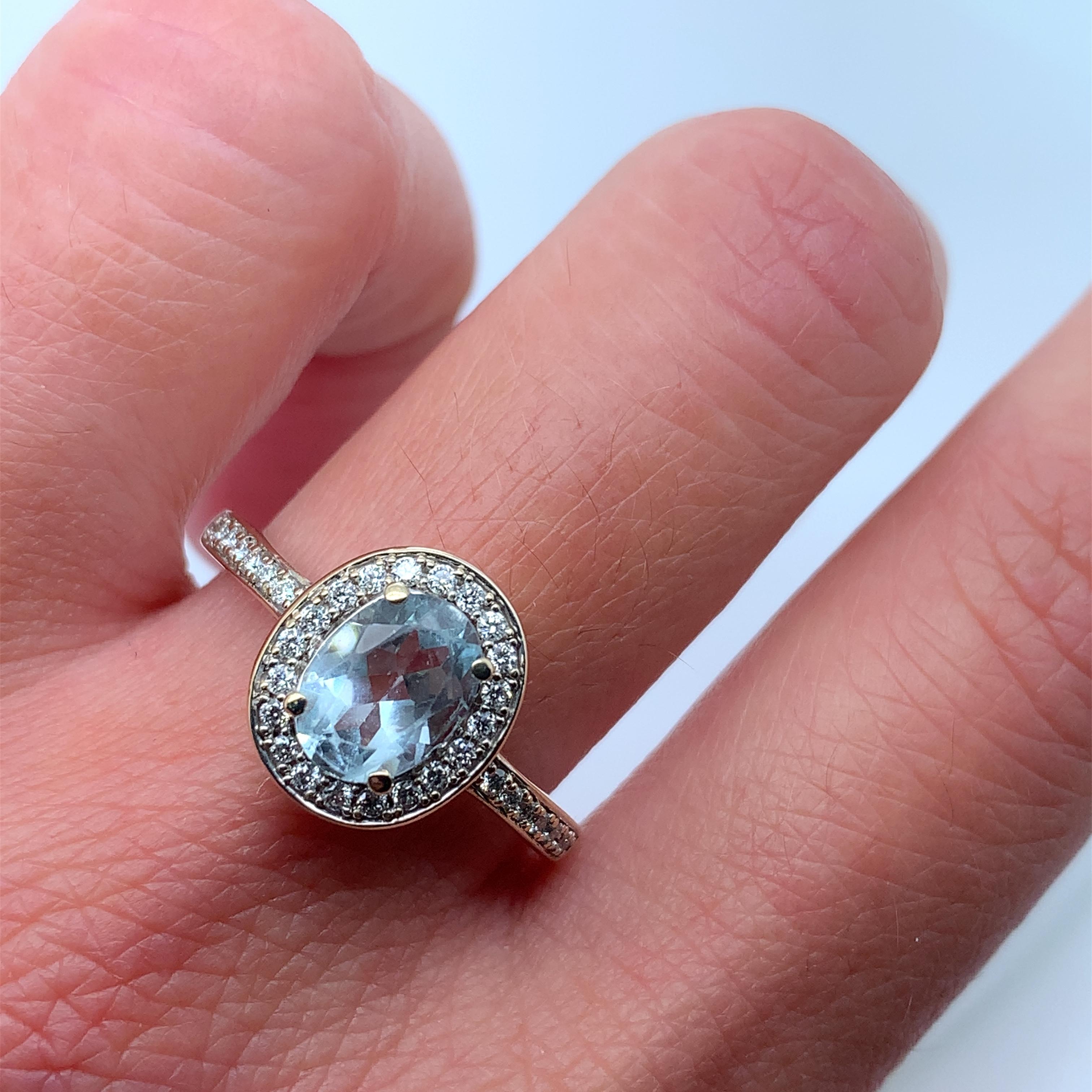 This stunning engagement ring is the perfect choice for any couple looking to make a statement. Crafted in 9k white gold, it features a beautiful blue sky aquamarine and diamond halo setting that surrounds the main stone, aquamarine weighing