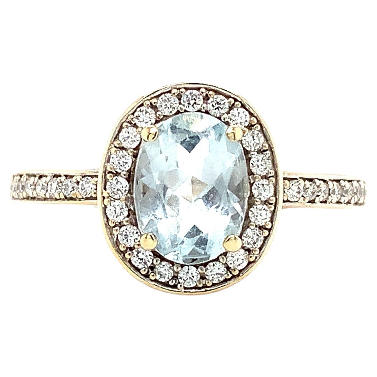 Aquamarine and diamond halo engagement ring white gold
