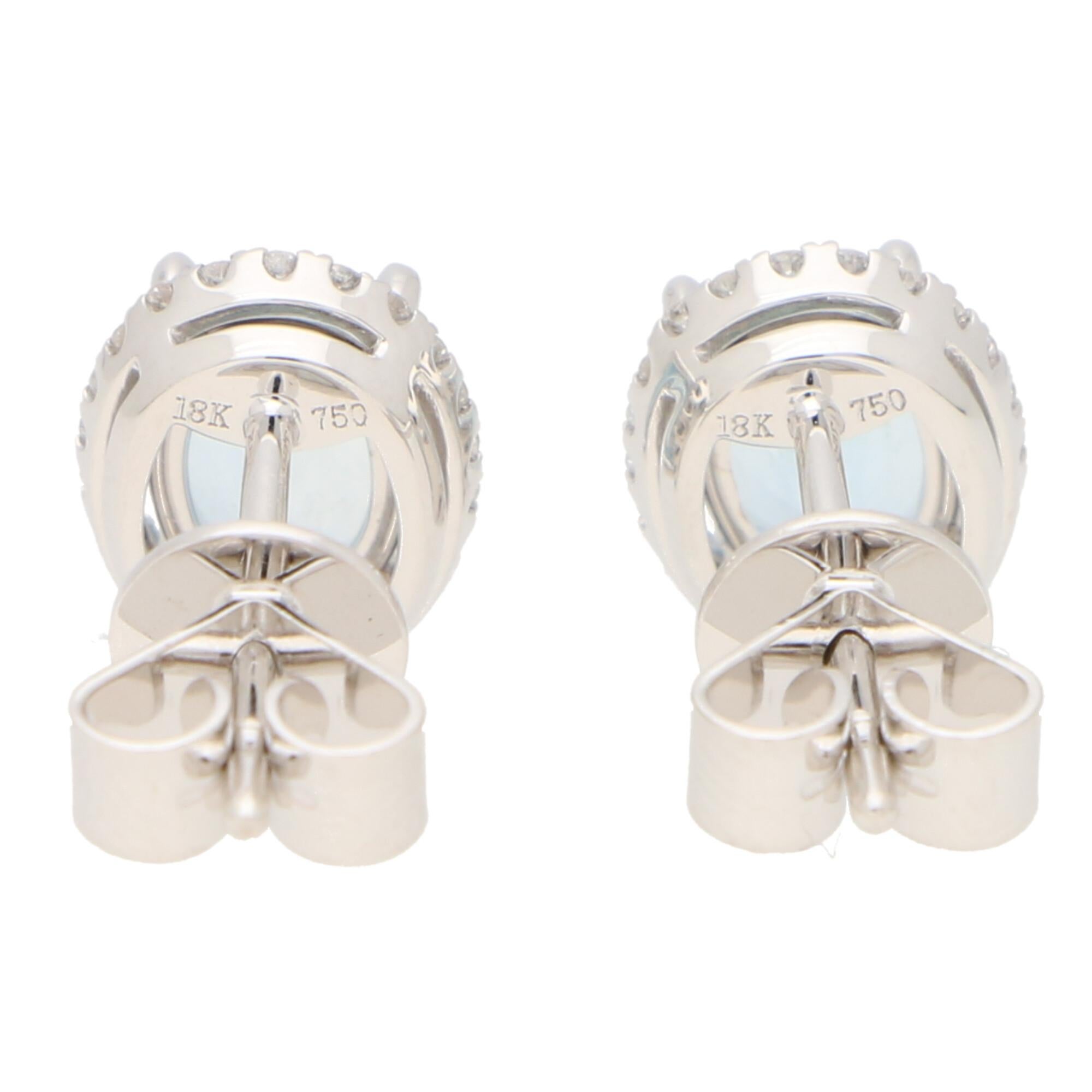 Oval Cut Aquamarine and Diamond Halo Stud Earrings Set in 18k White Gold