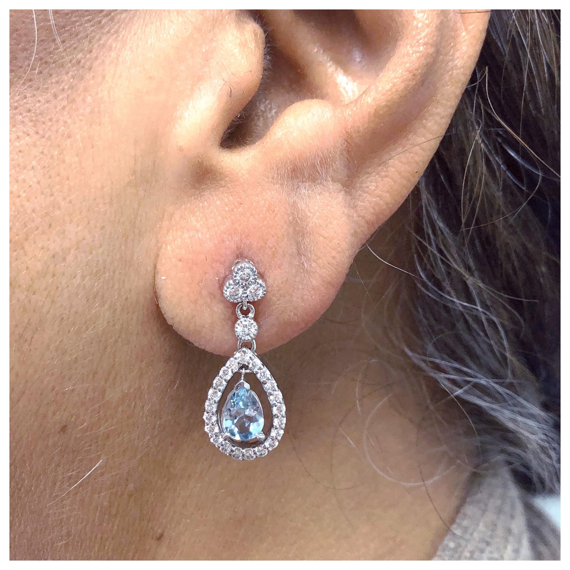 Beautiful vintage inspired 1.16ct. total weight of Aquamarine pear shapes, and .83ct total weight of G color SI clarity diamond melee. These drop earrings are made in 14kt white and are approximately 1 inch tall. We would be happy to work with you