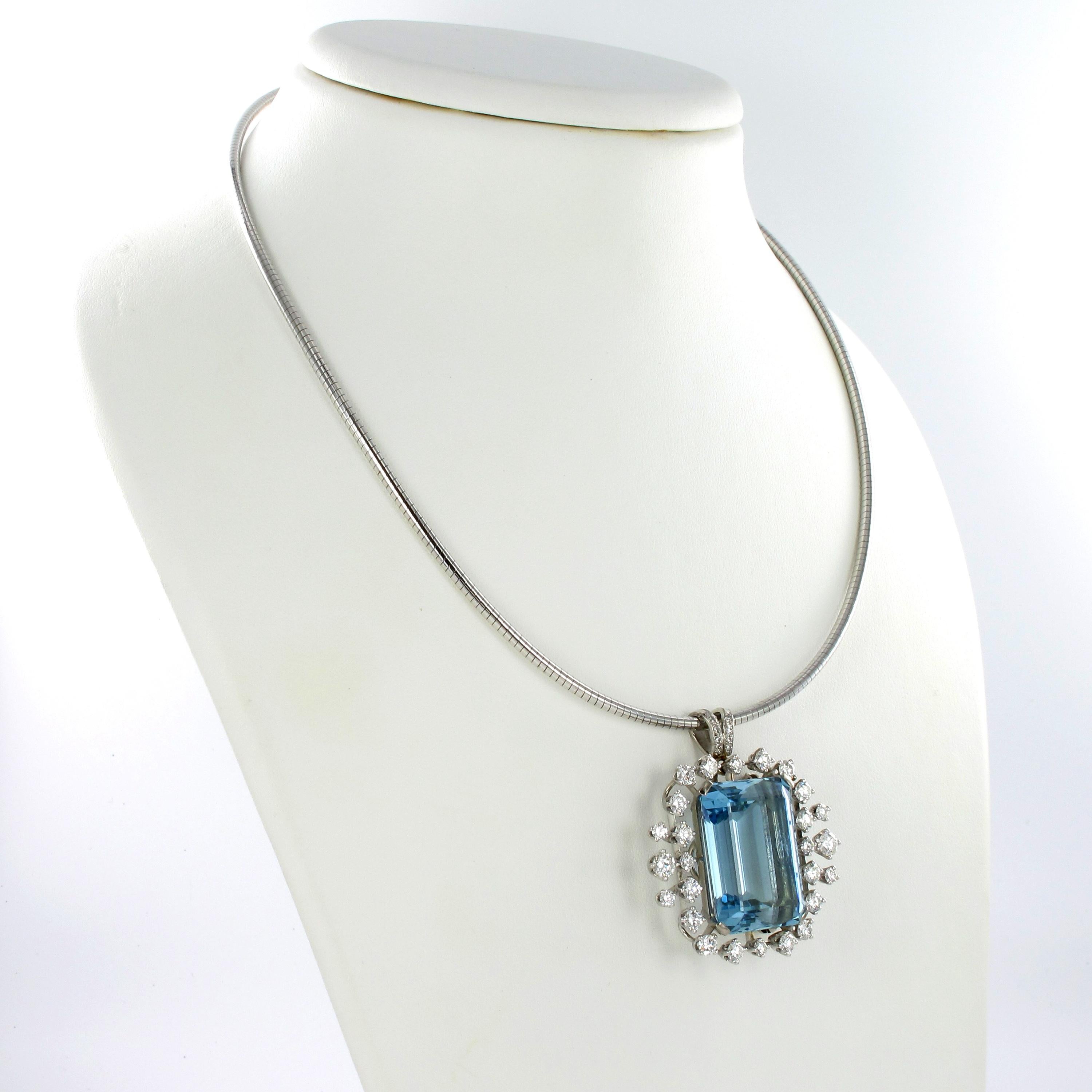 This beautiful pendant/brooch is prong-set with a 35.00 carat emerald-cut Aquamarine. Clean and of delightful colour, this lively aquamarine is surrounded by 26 brilliant-cut diamonds of G/H colour and vs clarity, total weight approximately 3.20