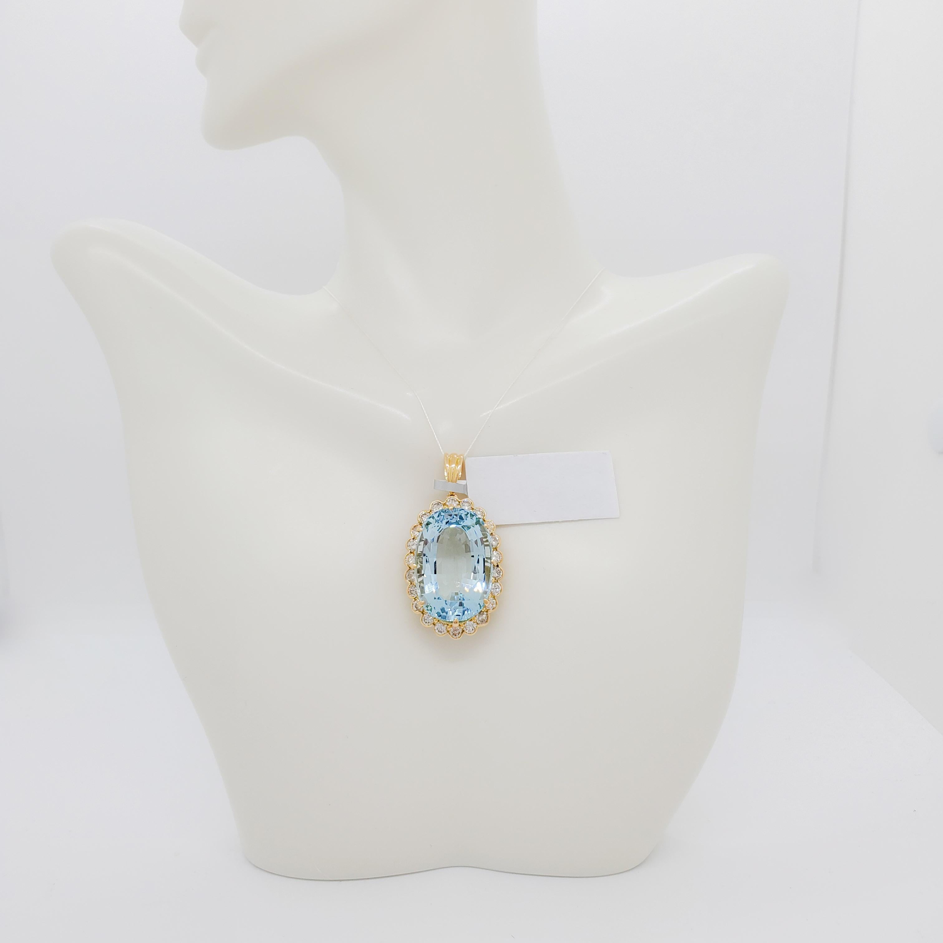 Beautiful 28.12 ct. aquamarine oval with 2.57 ct. good quality white diamond rounds. Handmade in 18k yellow gold.  This piece is well made and the aquamarine has a gorgeous color and crystal.