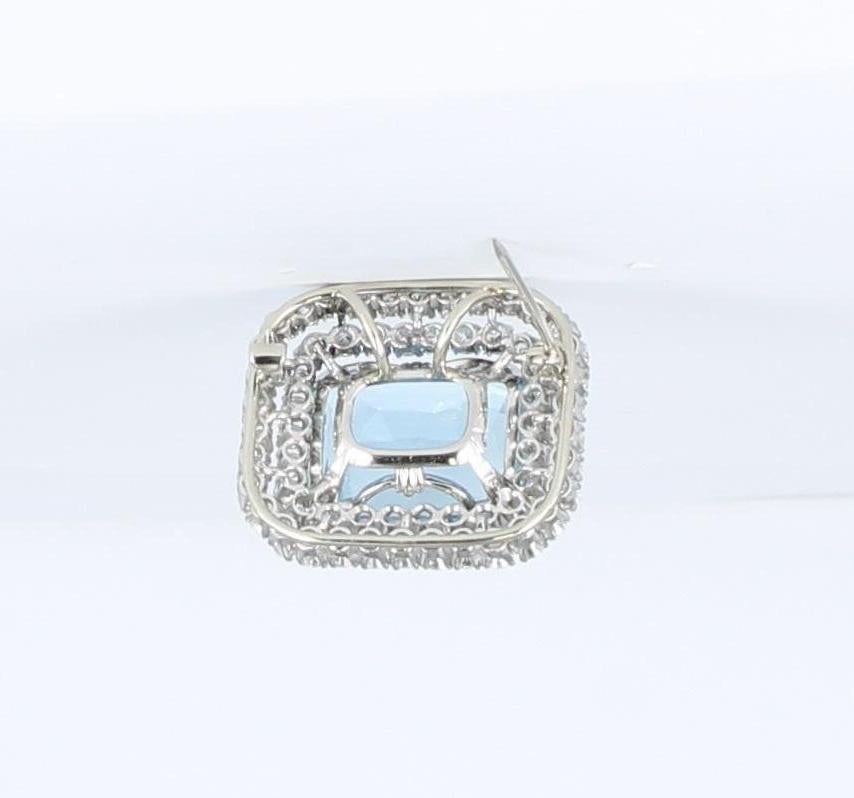This clear and dreamy blue aquamarine is 18 millimeters long and 14.5 millimeters wide and is as tempting as a pool of cool water.  There are two levels of diamonds, 4.0 carats total weight, surrounding the rectangular aquamarine.  This piece is