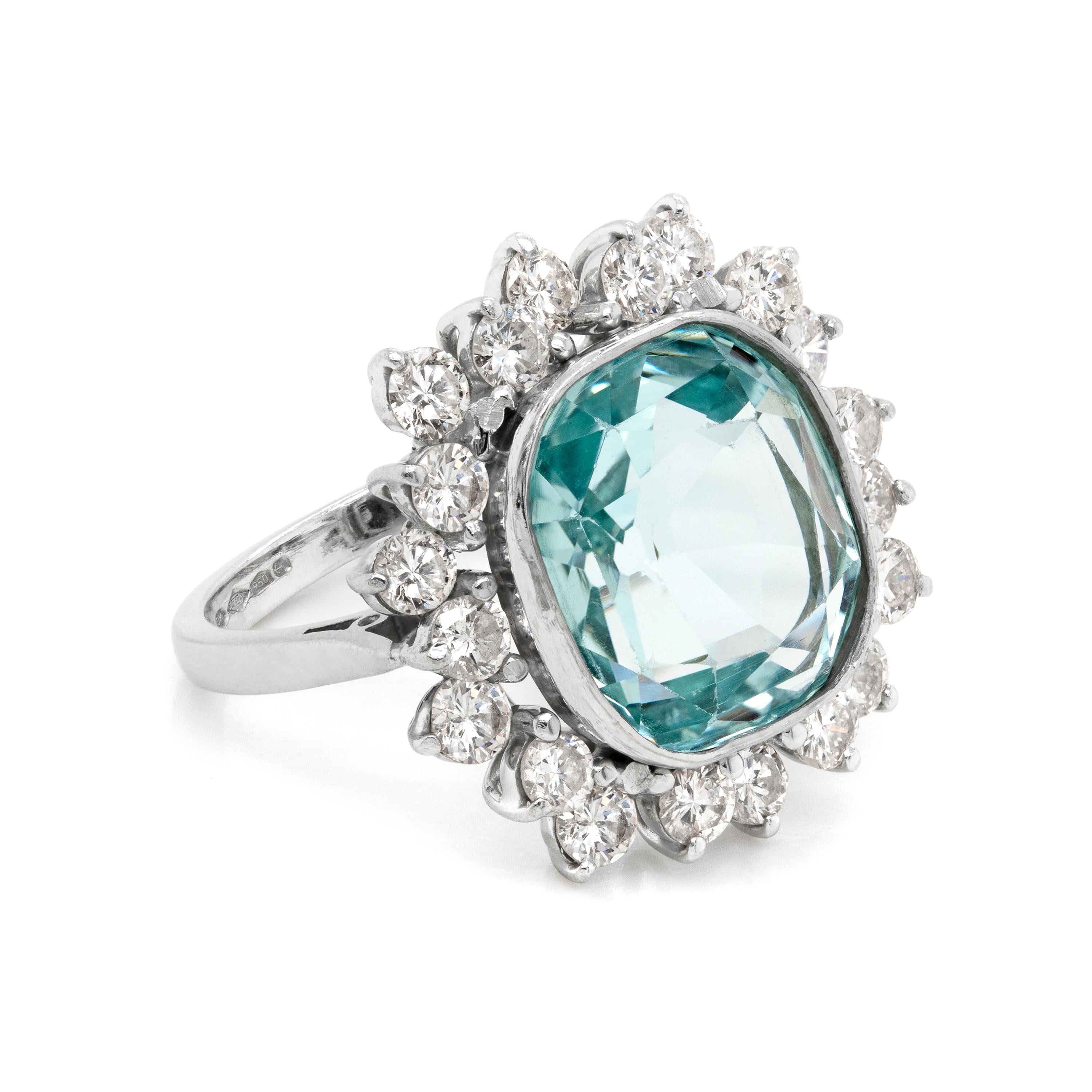 Incredible cluster ring featuring a cushion aquamarine, weighing approximately 4.50ct, mounted in a rubover, open back setting. The amazing aquamarine is beautifully surrounded by twenty round brilliant cut diamonds, weighing a total approximate