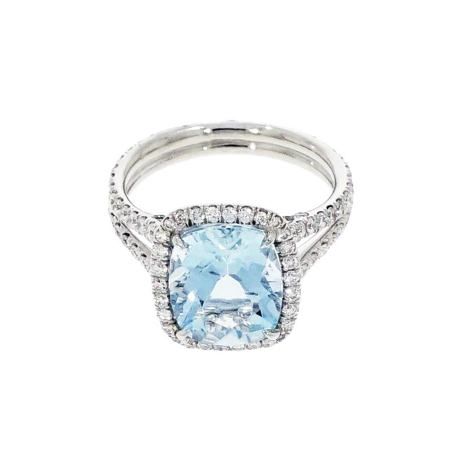 This exceptional Cocktail Ring features a 3.56 carat cushion shaped Aquamarine center, surrounded by a halo of white round diamonds gently accenting the curve around the Aquamarine for a distinctive look. 
A row of pavé diamonds is set on the