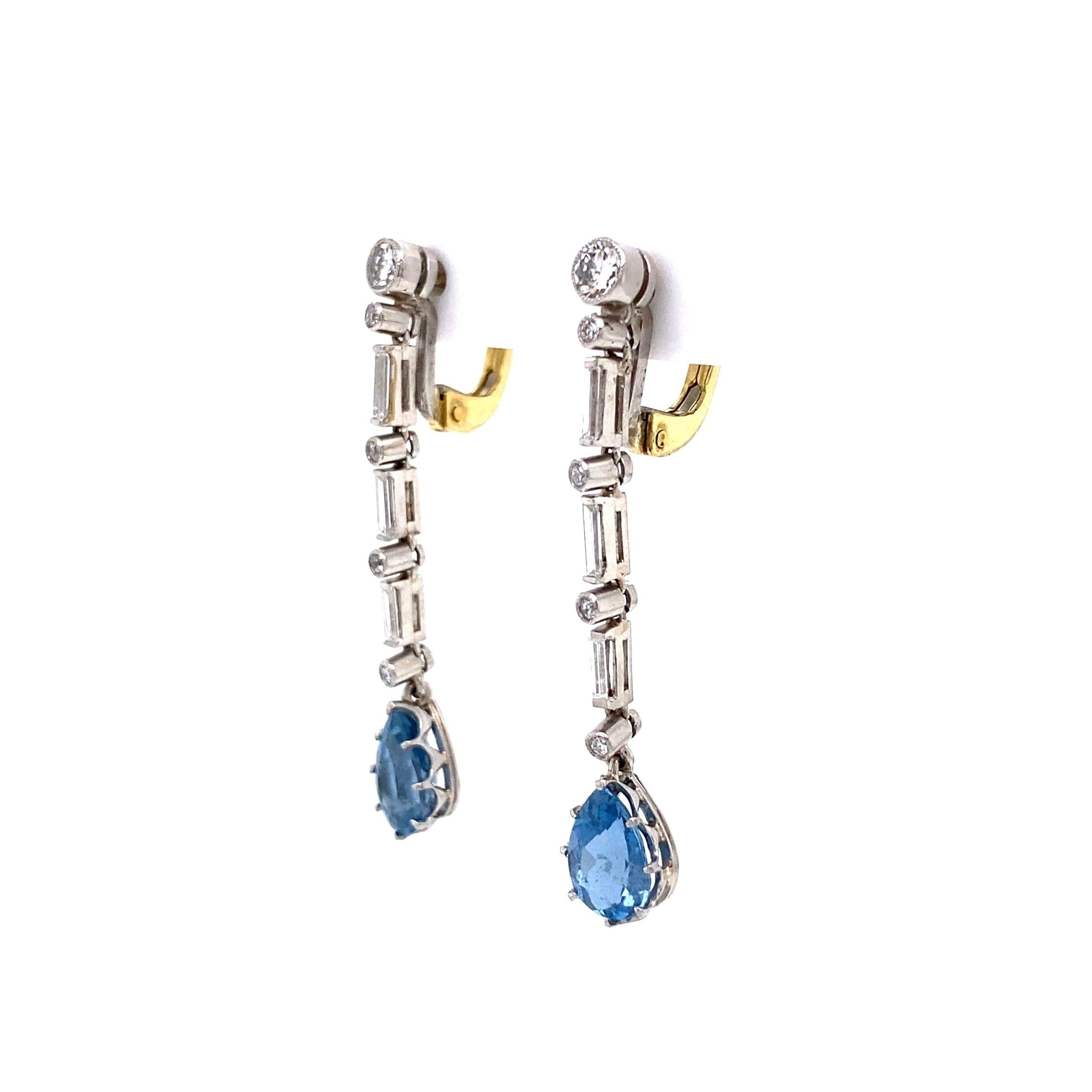 Stunning Aquamarine and Diamond Platinum Drop Dangle Earrings. Beautifully Hand crafted in Platinum. Each Drop Earring Hand set with alternating round and baguette Diamonds, suspending a pear shape deep blue Aquamarine. Approx. 0.76tcw of Diamonds