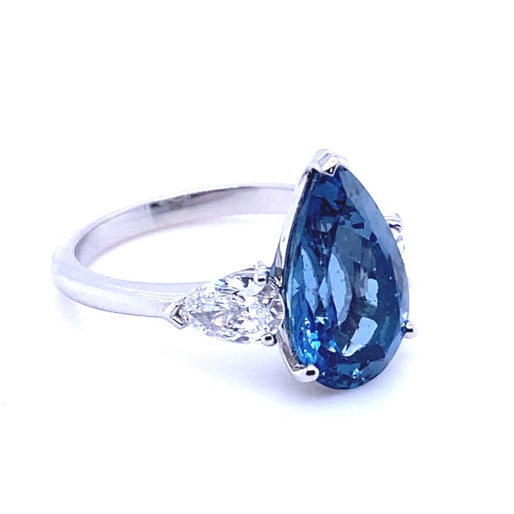 An aquamarine and diamond platinum engagement ring.

This beautiful pear cut aquamarine and diamond engagement ring is handcrafted in platinum. The piece is set to its centre with a pear brilliant cut aquamarine of 3.75 carats.
This striking stone