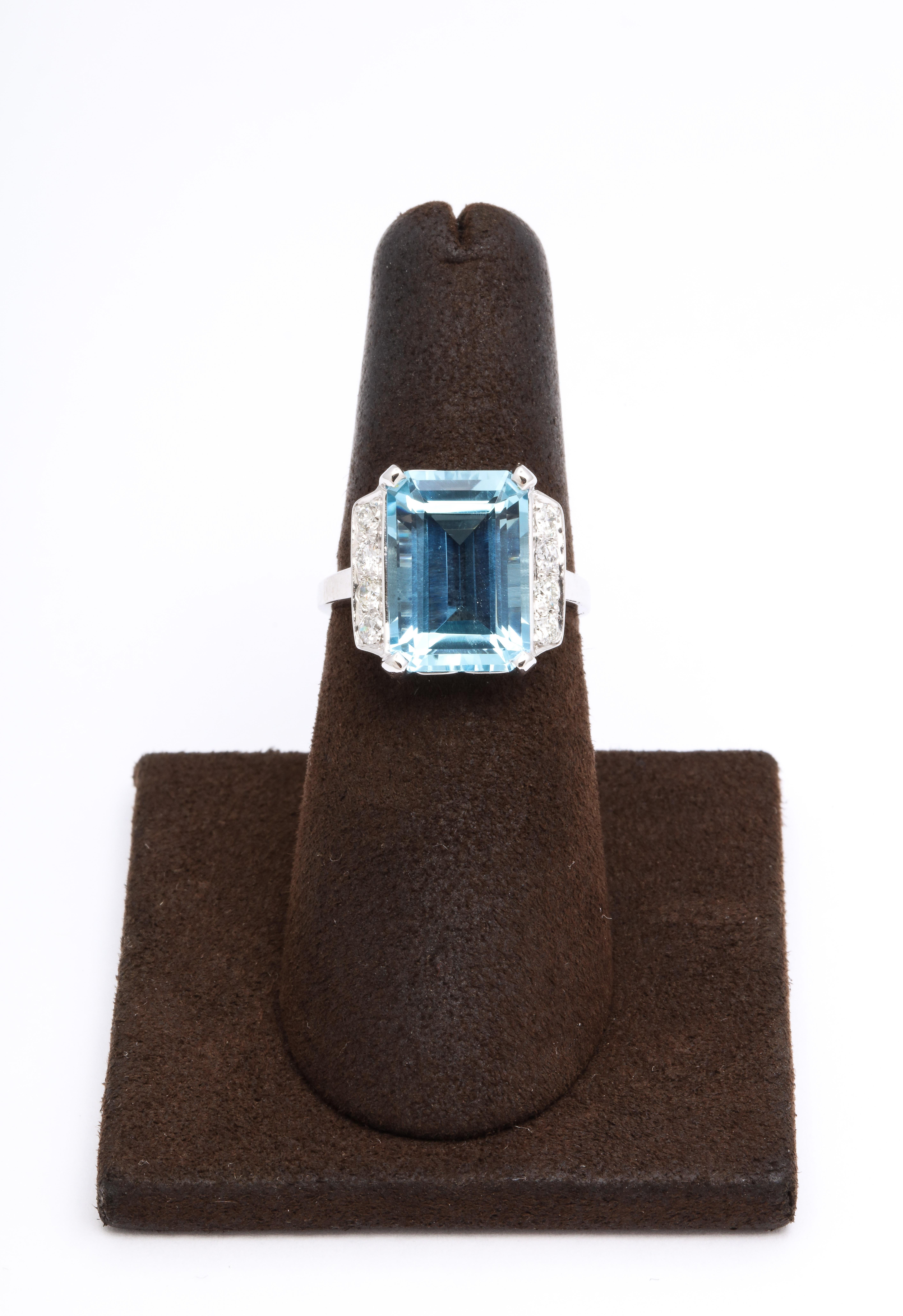 
4.58 carat emerald cut Aquamarine

.40 carats of white round brilliant cut diamonds. 

Approximately 14.2 mm long.

Set in platinum 

Size 5.75, can easily be resized. 

A timeless piece -- a PERFECT gift!