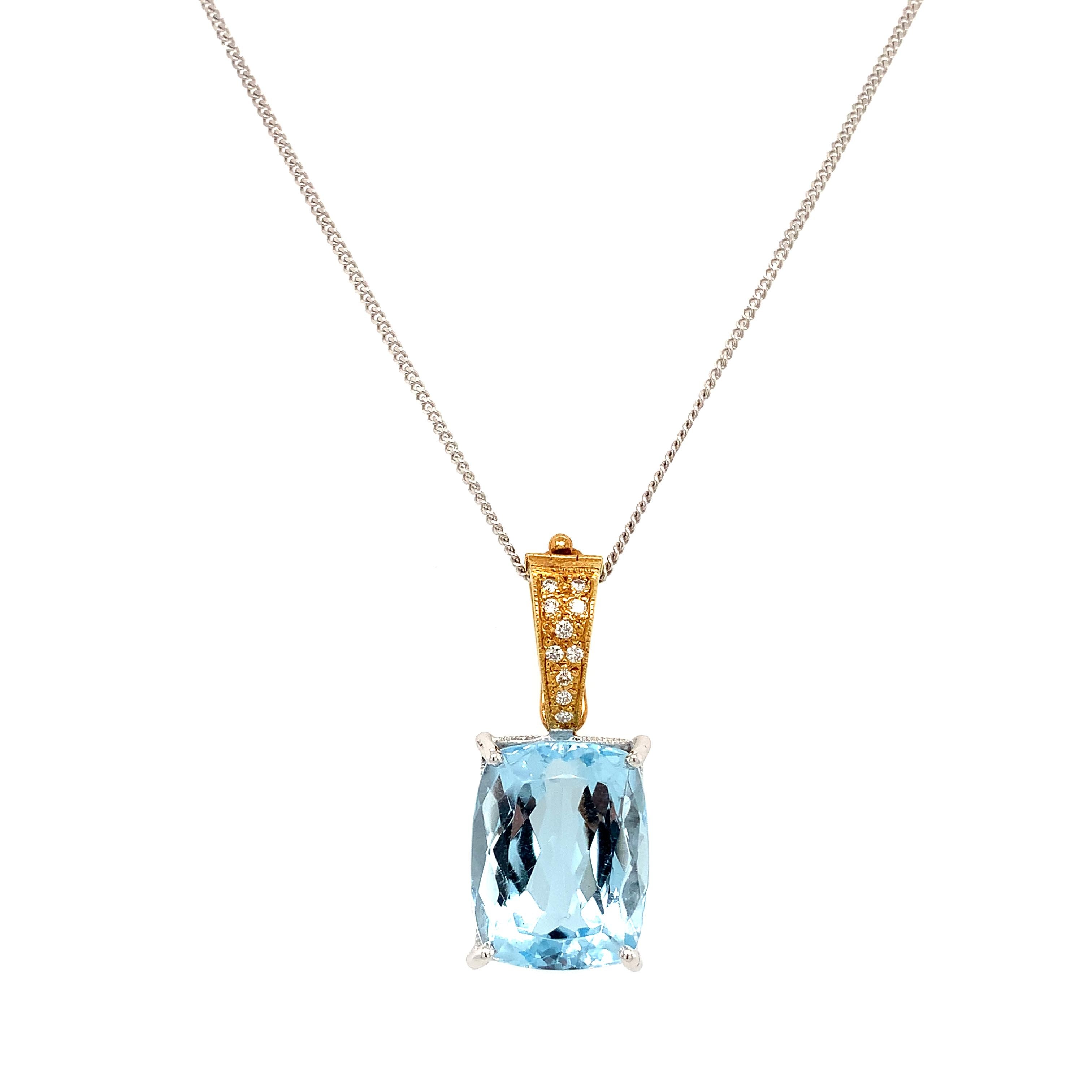 Elevate your jewellery collection with this stunning 10.46ct Aquamarine cushion cut and diamond art deco drop pendant. Crafted from 18k yellow and white gold, this pendant features a bezel setting style and boasts a round shape. The main stone shape